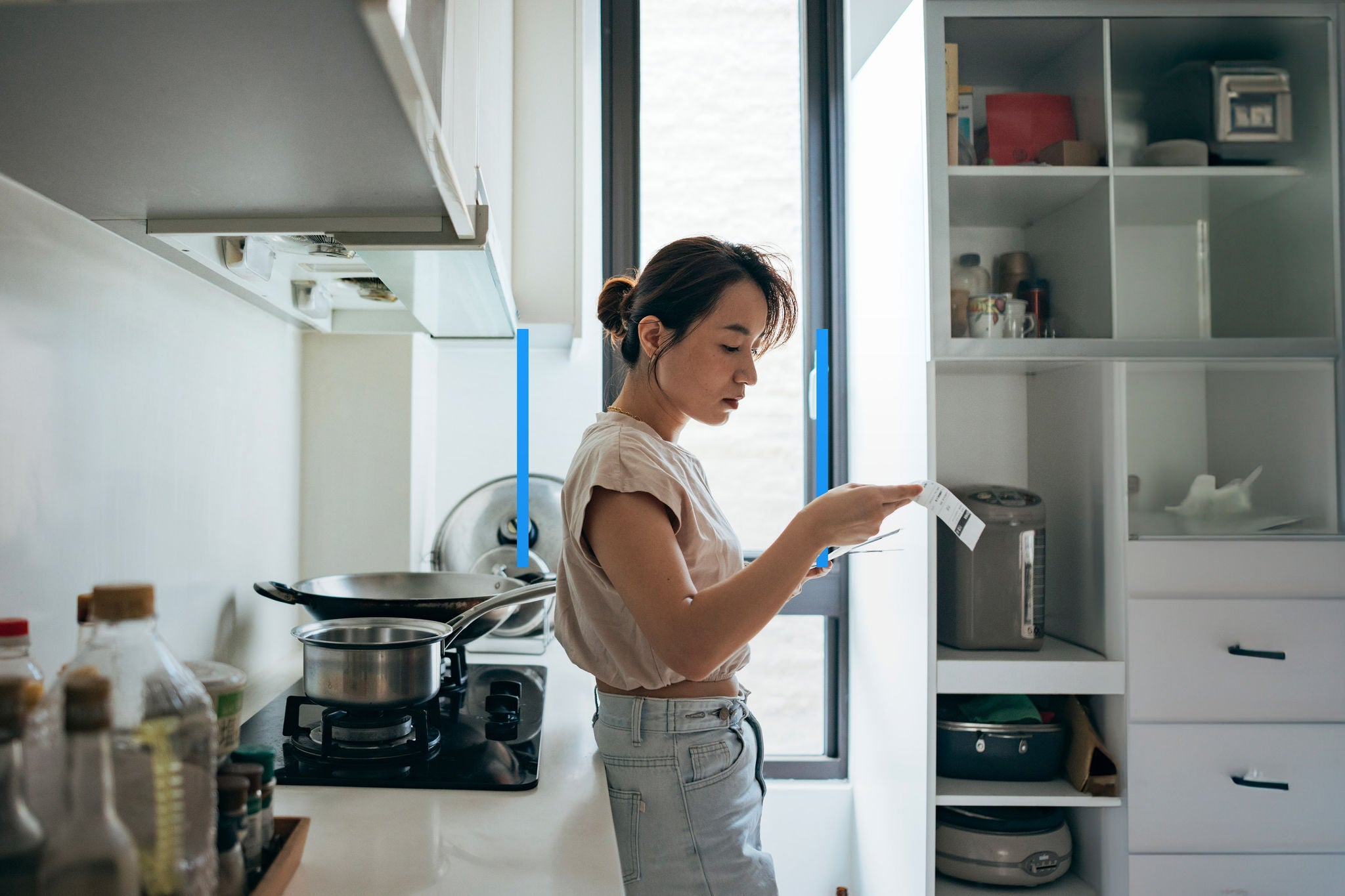 Asian women examining the shopping receipt at home 