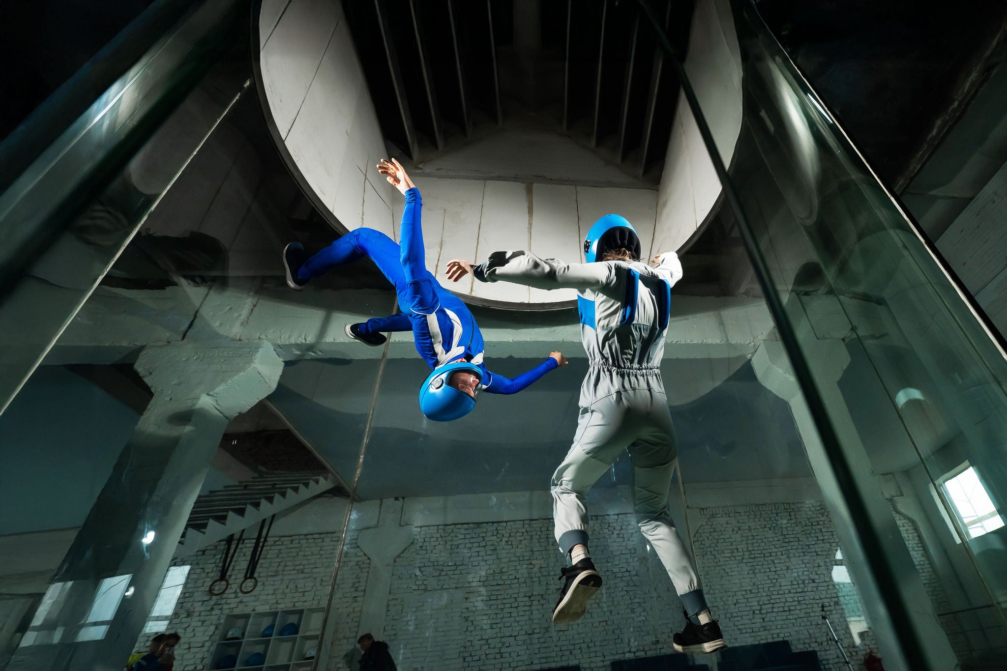 Man and a woman enjoy flying together in a wind tunnel.