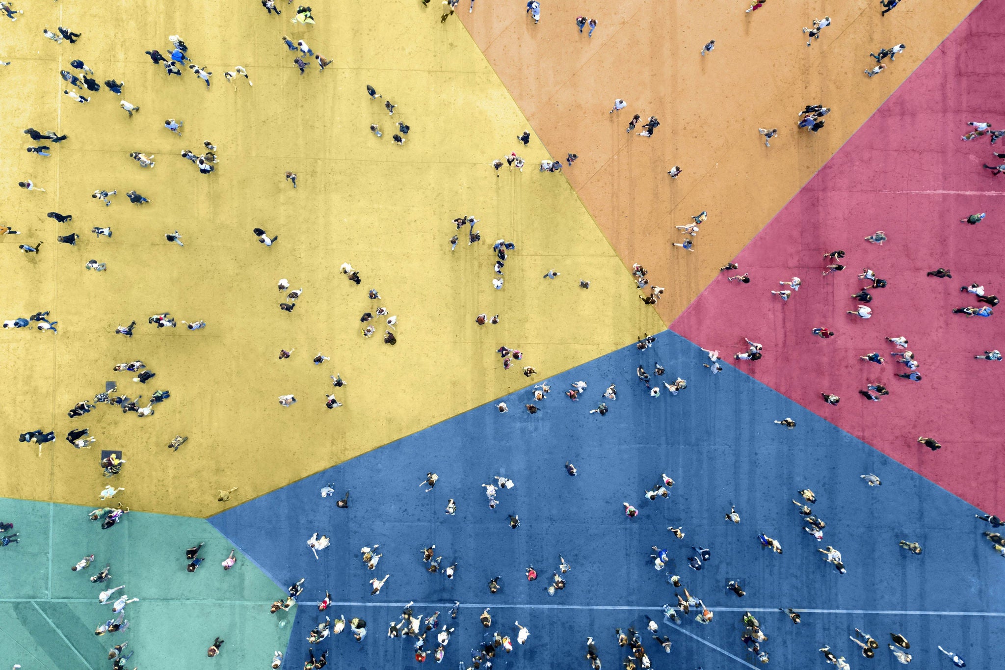 Overhead view of people walking on colorful block flooring