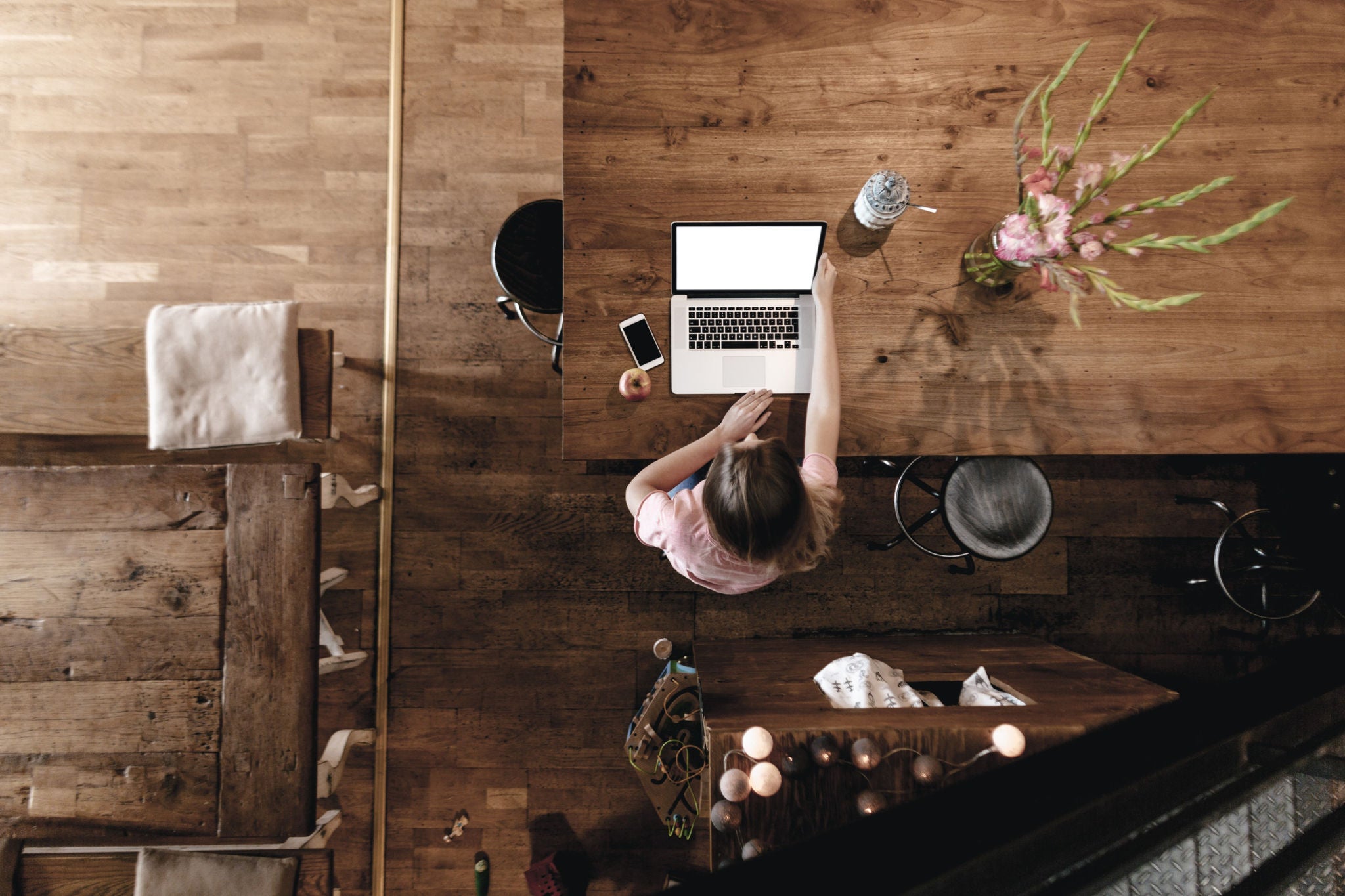 a woman working on a wooden desk