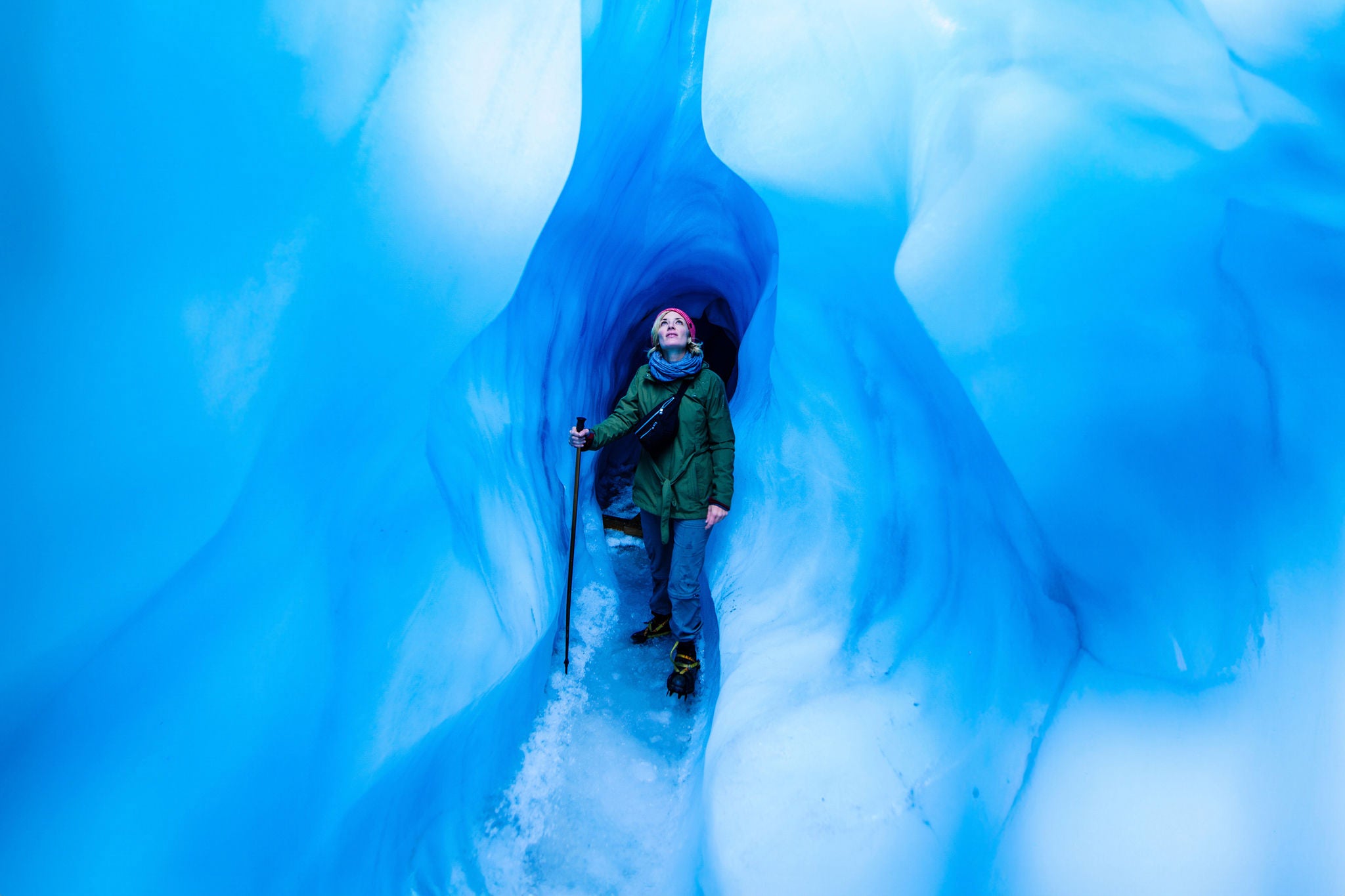 Woman standing in an ice cave, Fox Glacier, South Island, New Zealand