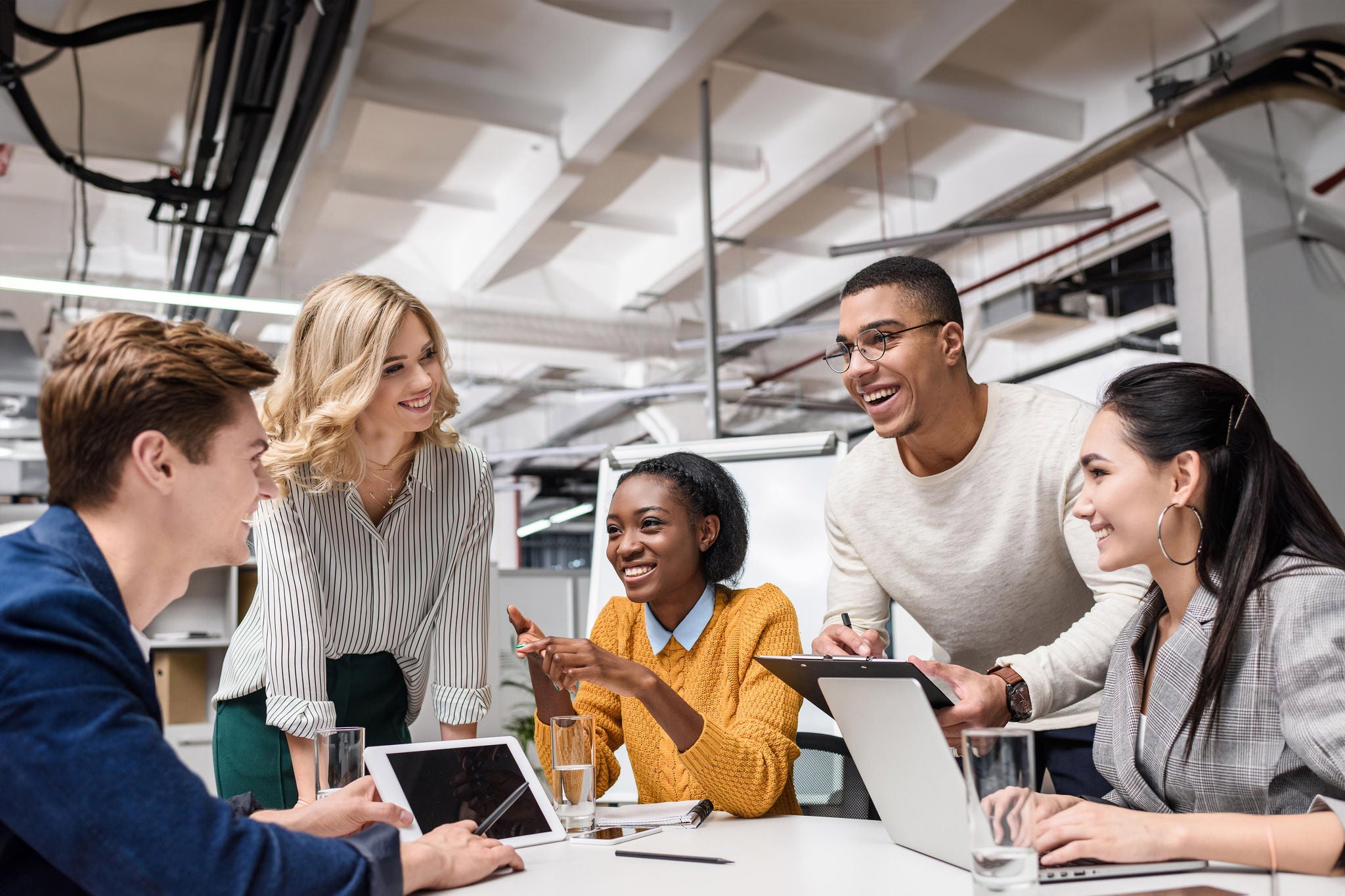 young happy managers working together at conference hall in modern office