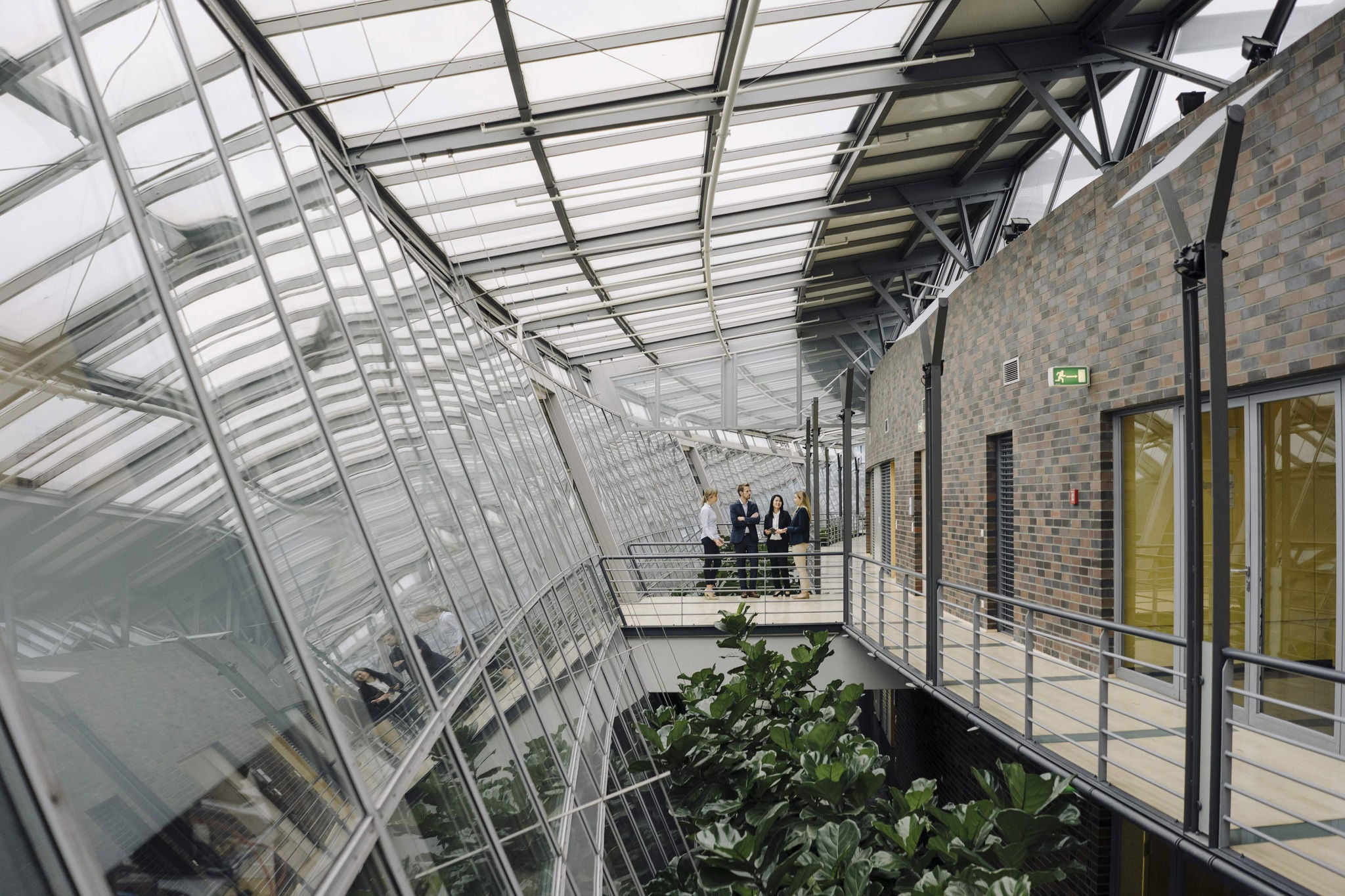 Business people standing on a skywalk in modern office building