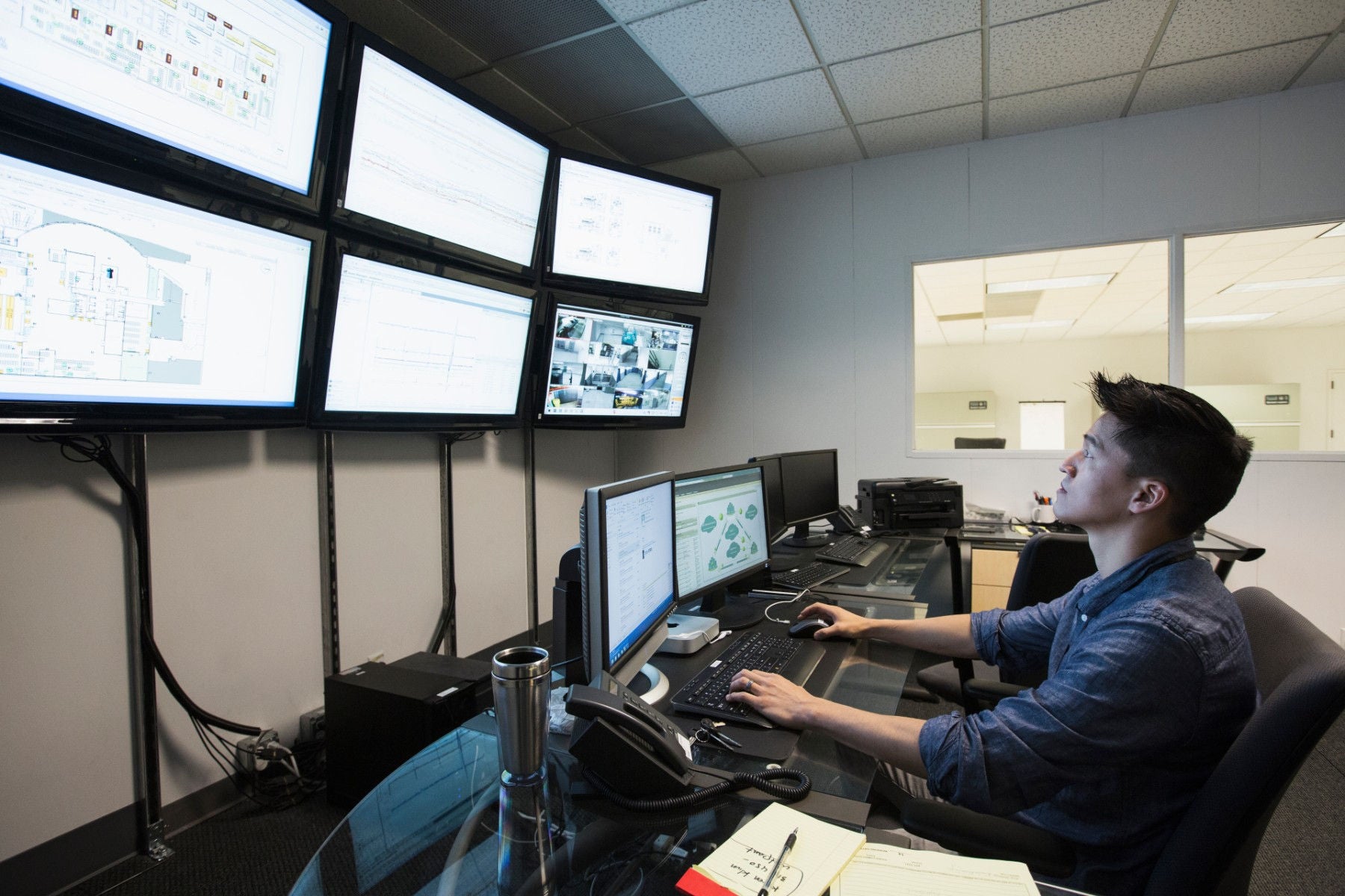 Man working in front of multiple monitors