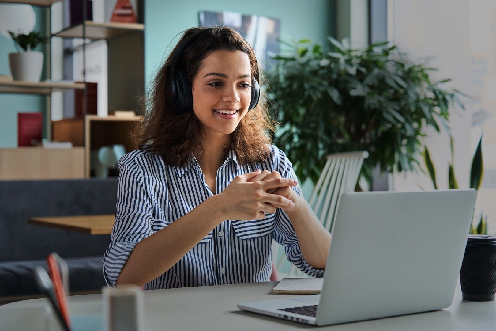 Girl sitting infront of laptop and talking