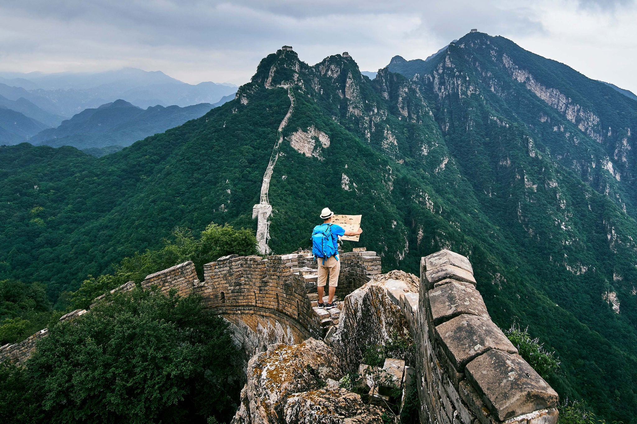 Man carrying a map on China mountains