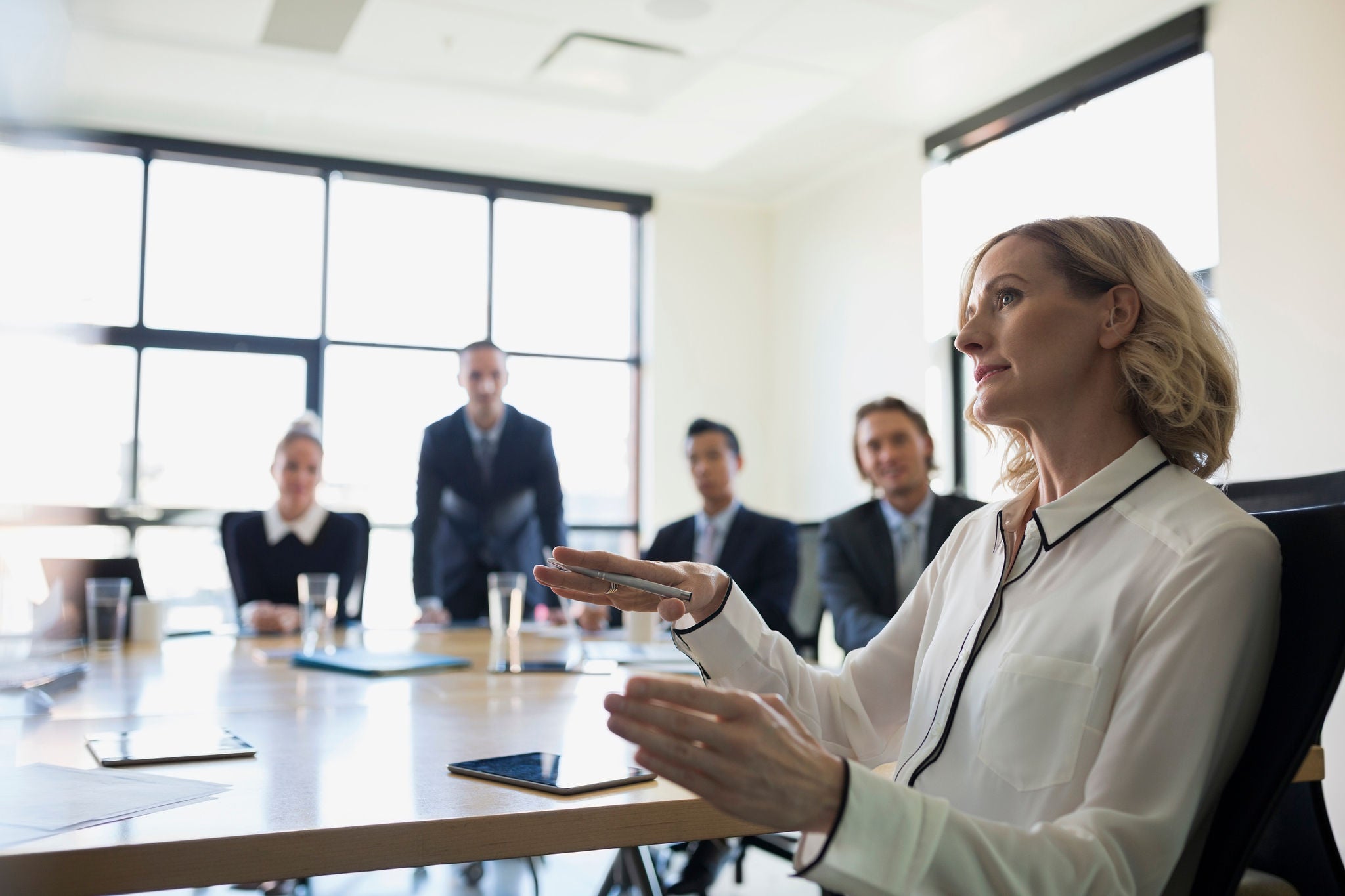 Businesswoman gesturing in conference room meeting