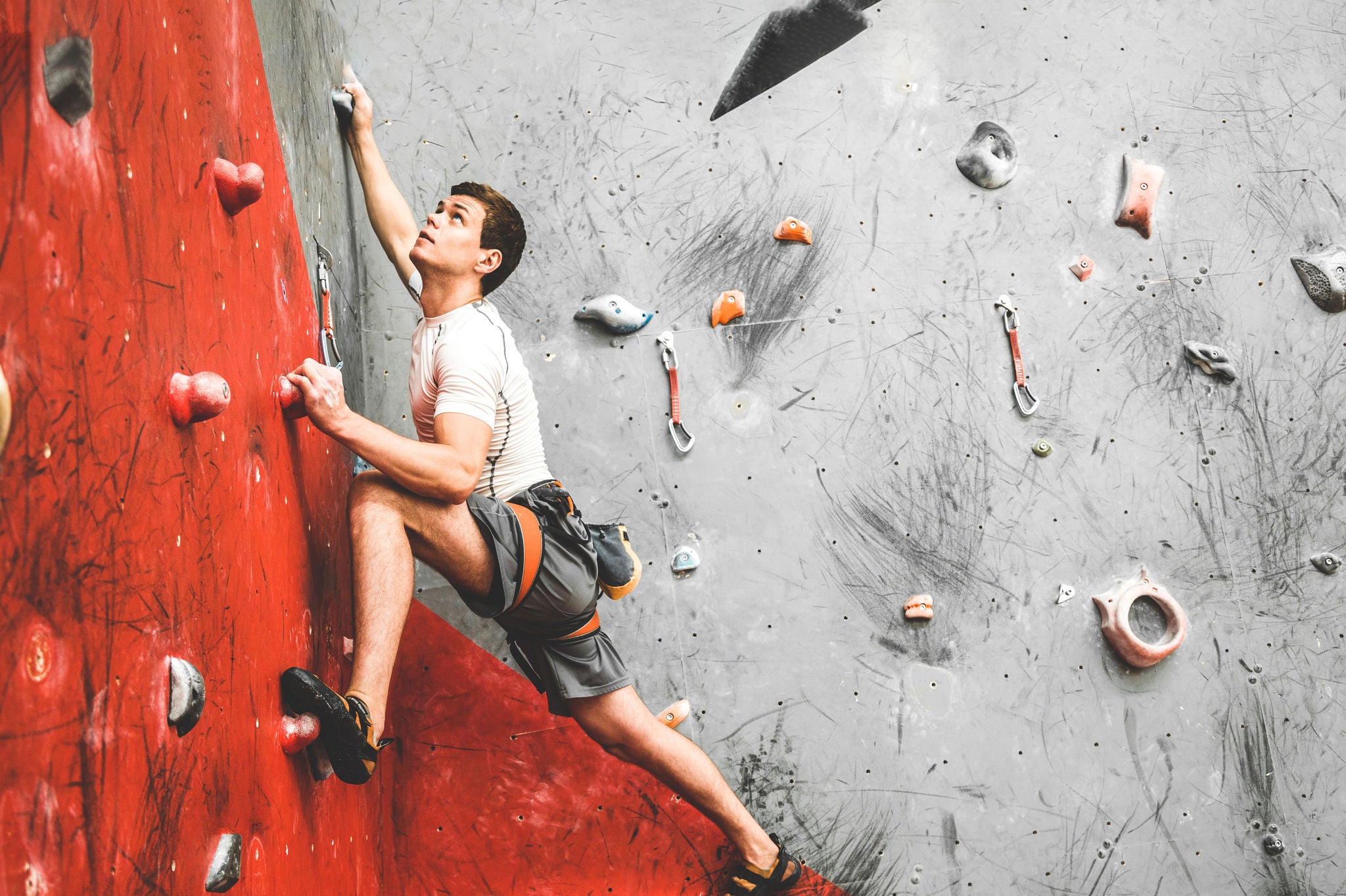 Sportsman climber moving up on steep rock