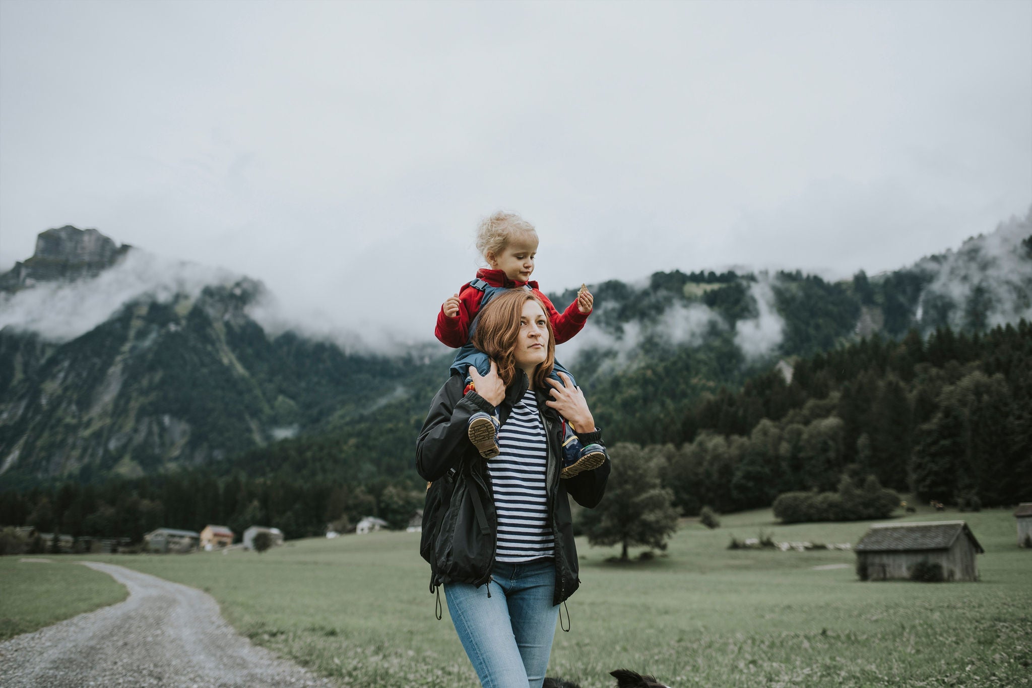 Women carrying child and walking