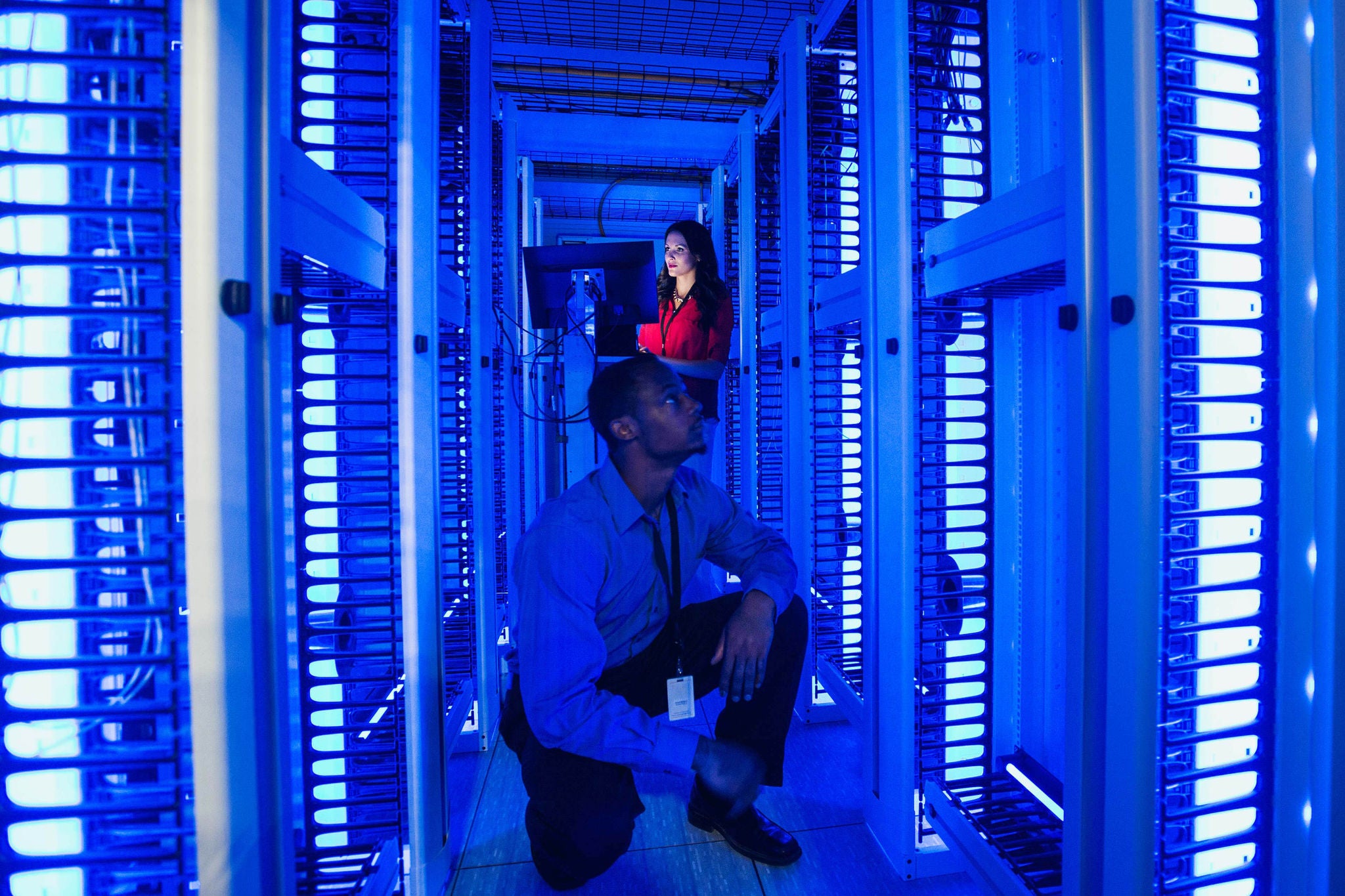 Business people working in server room