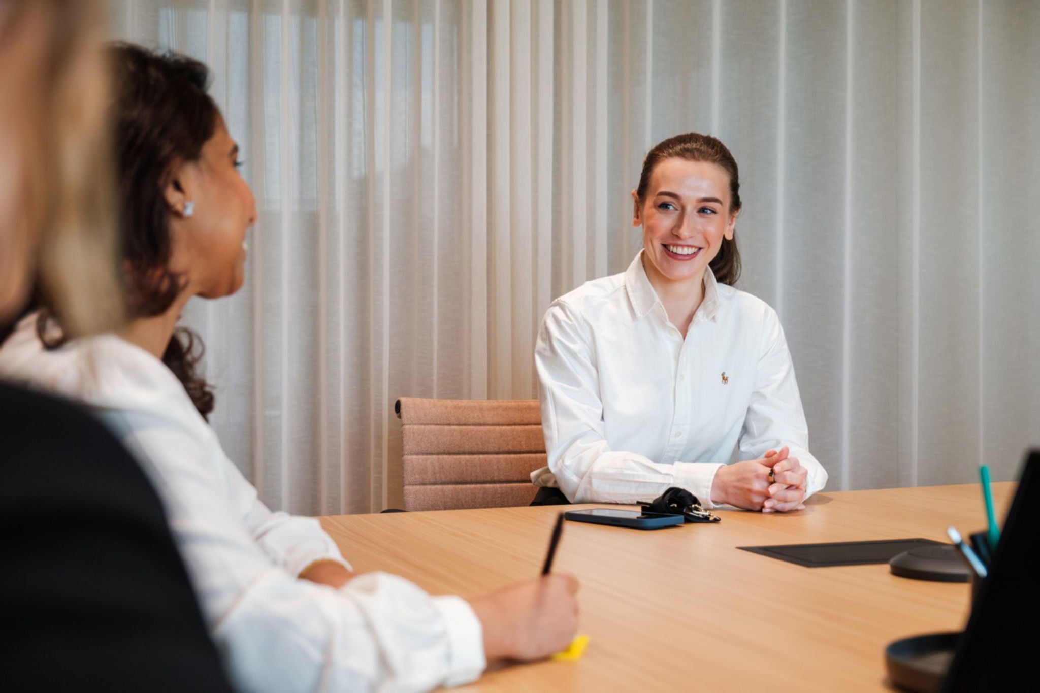 Group of colleagues sitting at meeting table