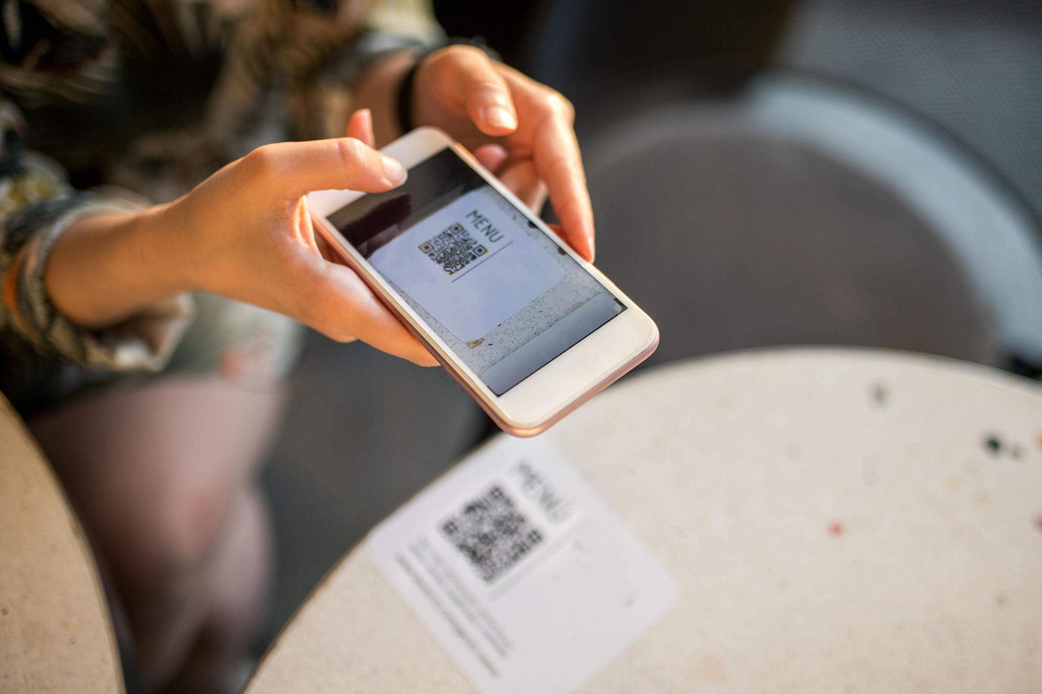 ey woman scanning qr code for online menu