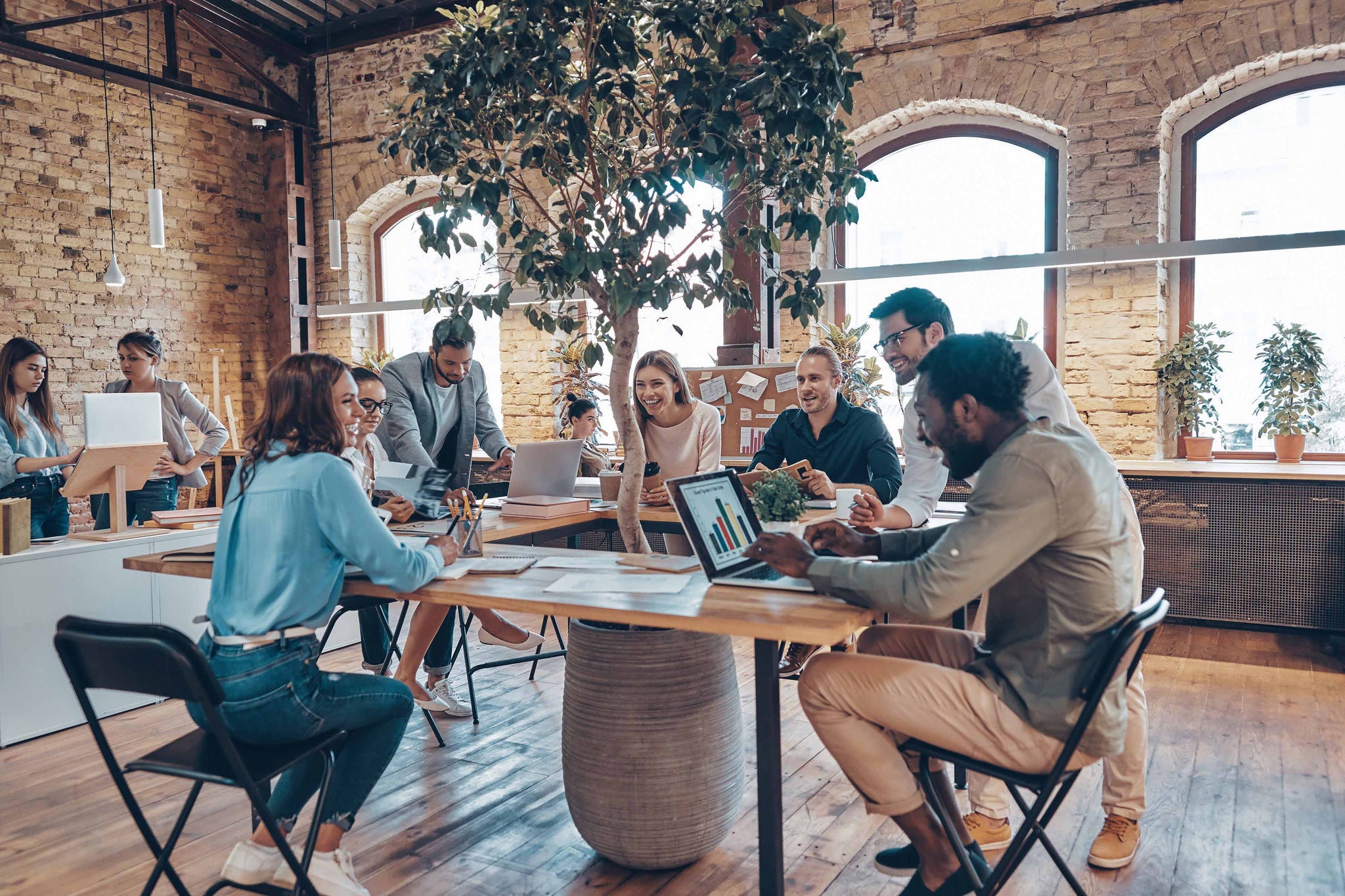 Group of young modern people in smart casual wear communicating