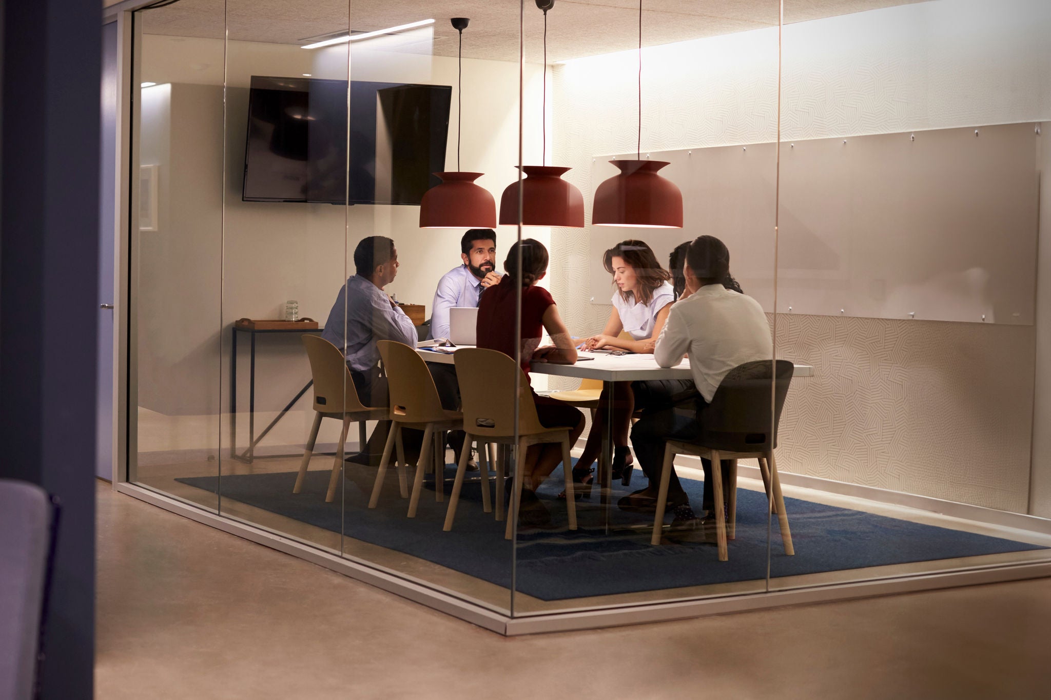 Corporate business team at table in a meeting room cubicle