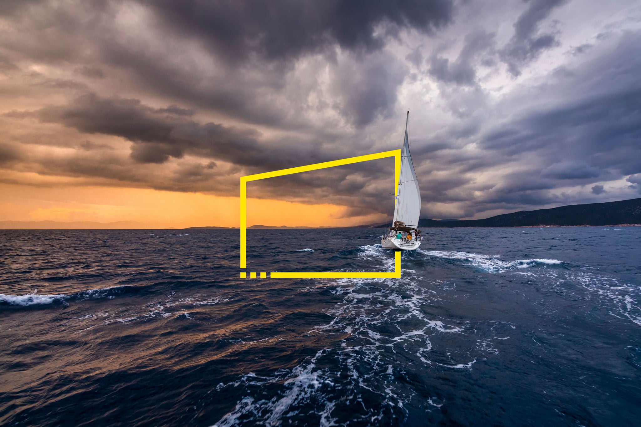 Yacht with white sails on a background of storm clouds at sea