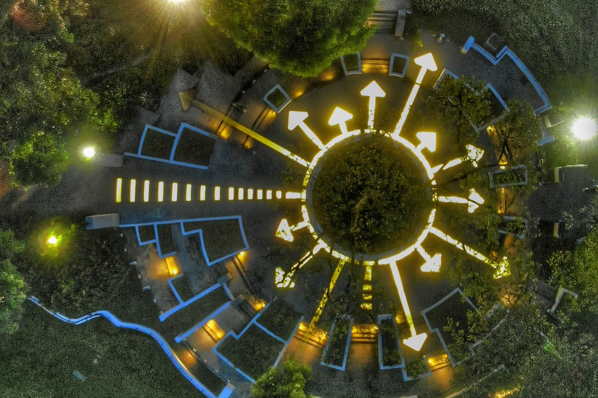 Top down view of a tree lit up be arrows pointing all around it