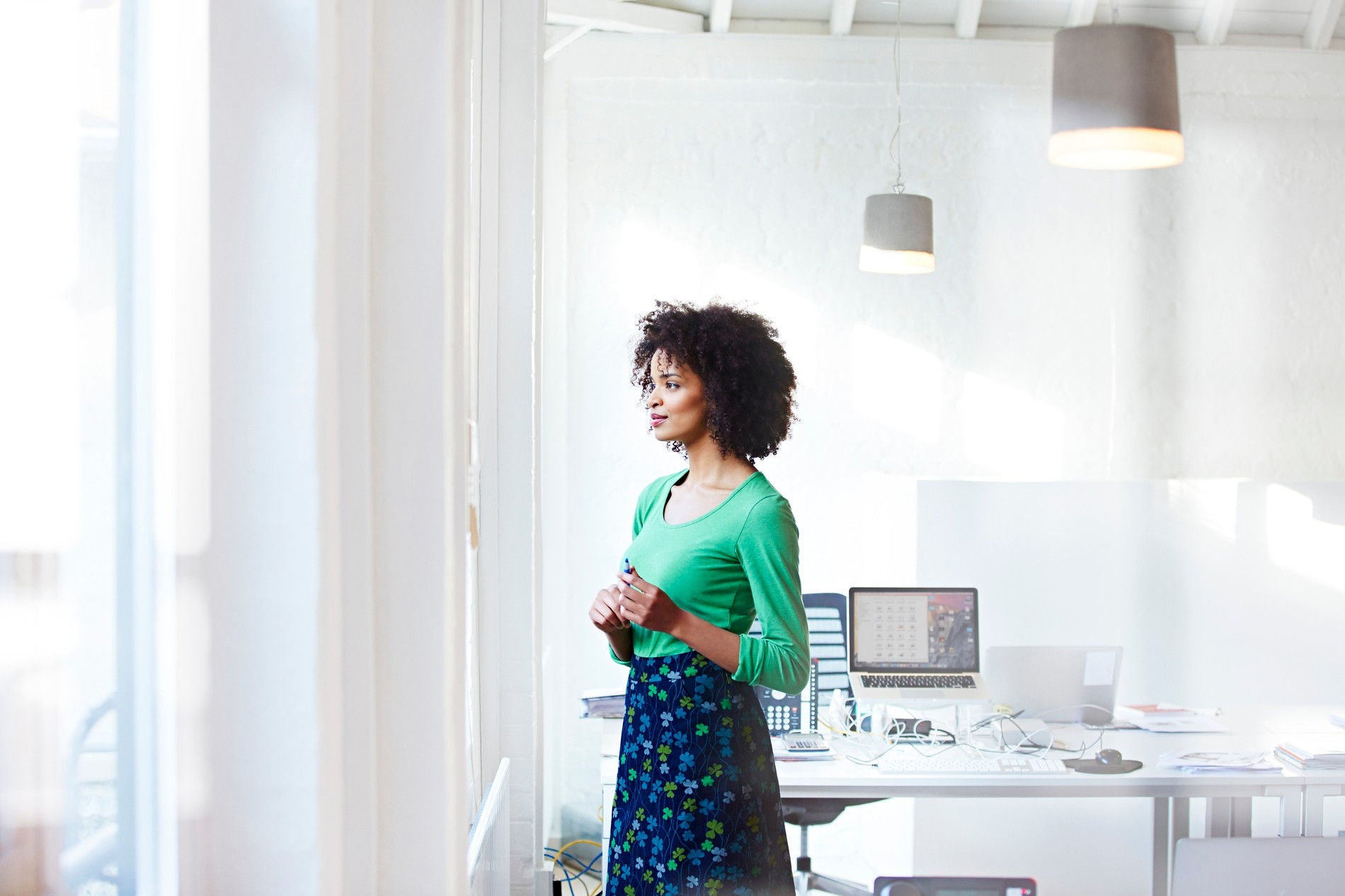  Businesswoman staring out the window at home