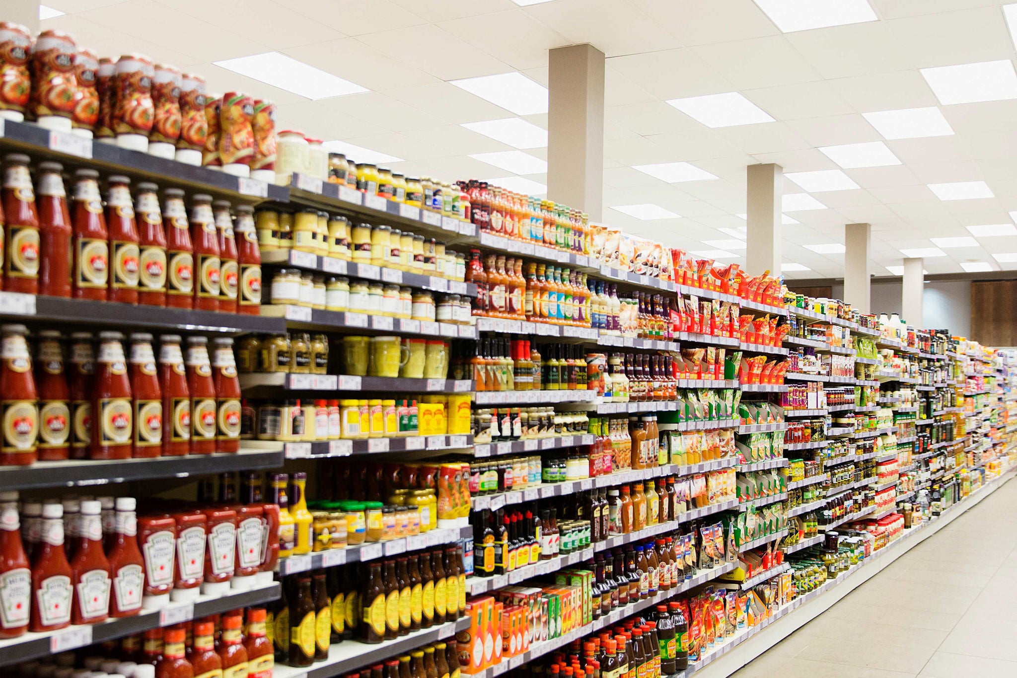 Stocked shelves in grocery store aisle  section 3 divider image