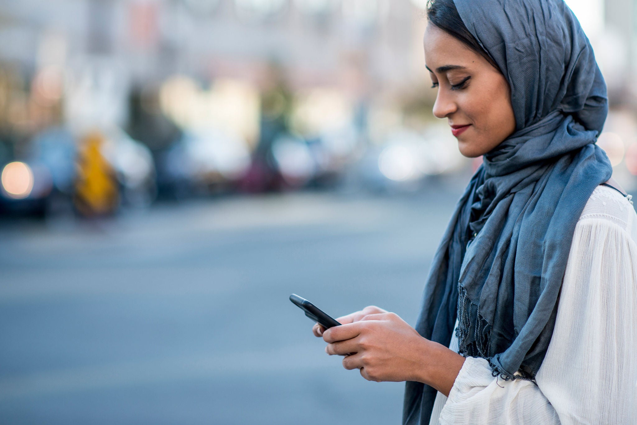 A woman using technology in outdoor on a sunny day