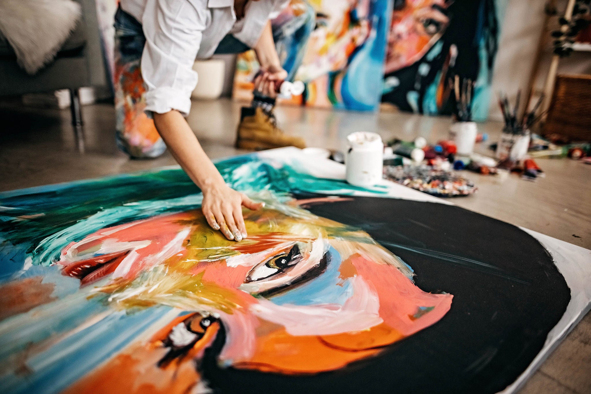 Female artist painting portrait on canvas