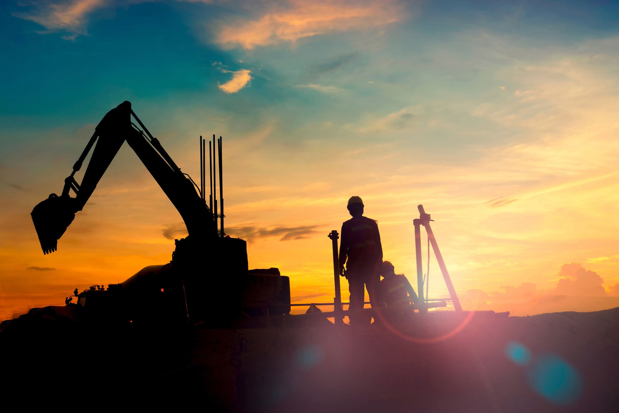 construction equipment's silhouette on sunset