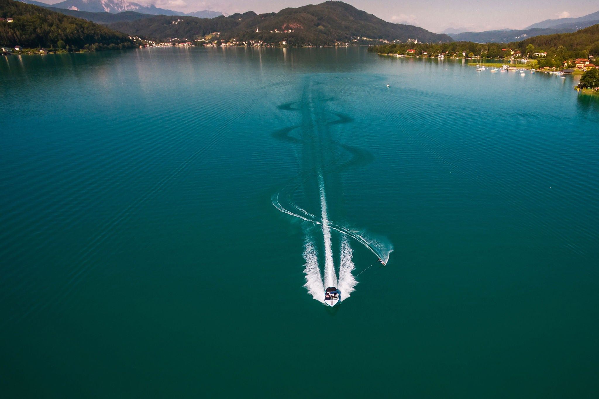 Motorboat pulling waterskier on lake in austria