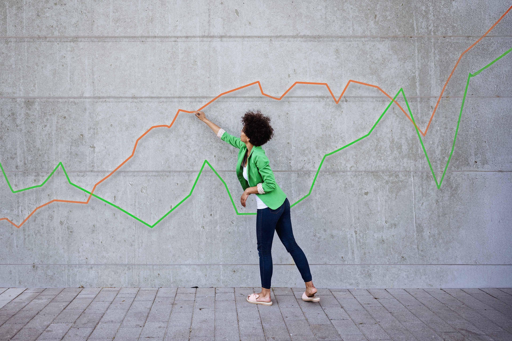 Young woman pointing at chart painted on wall