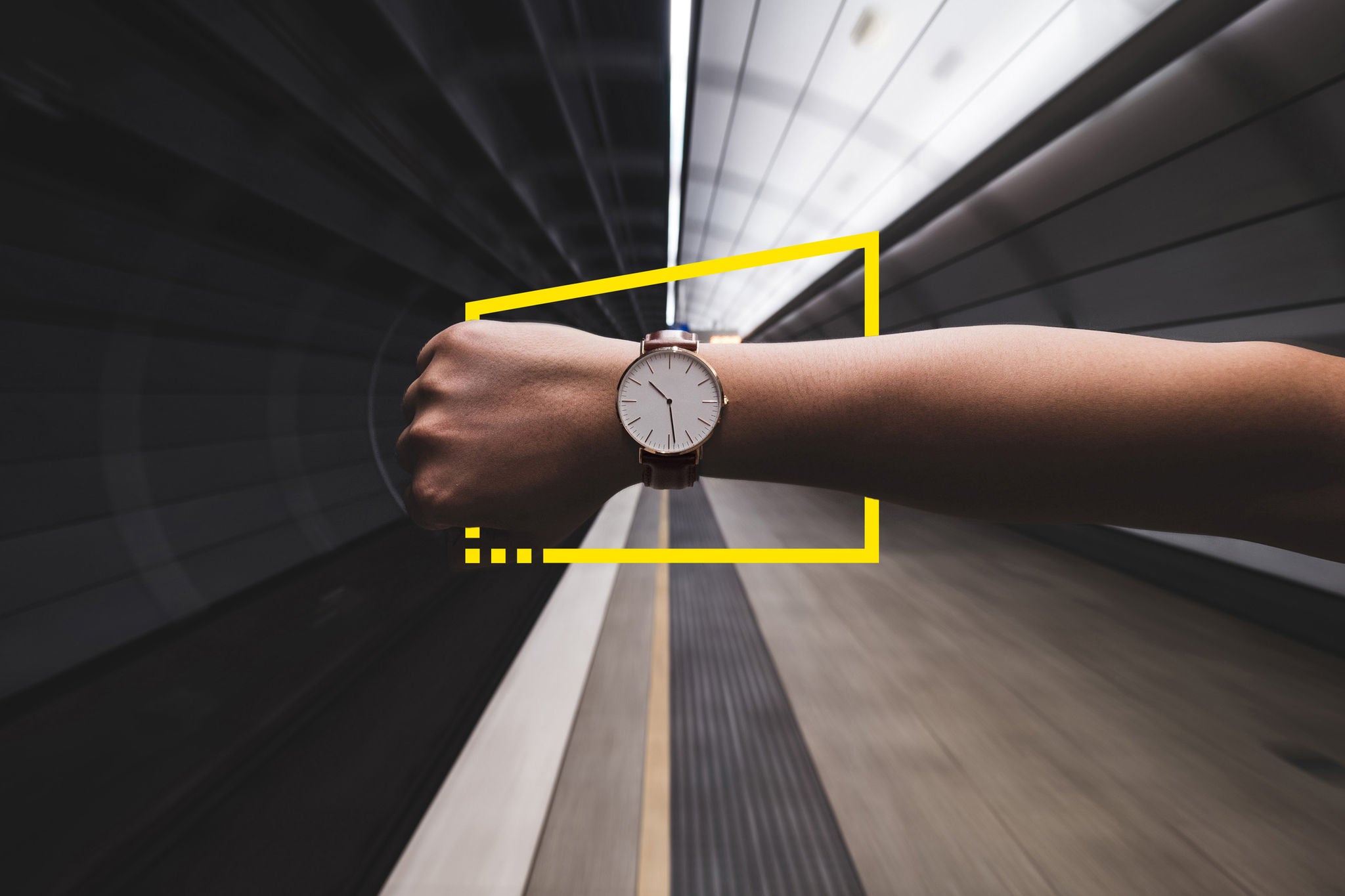 Woman hand showing wristwatch at subway station