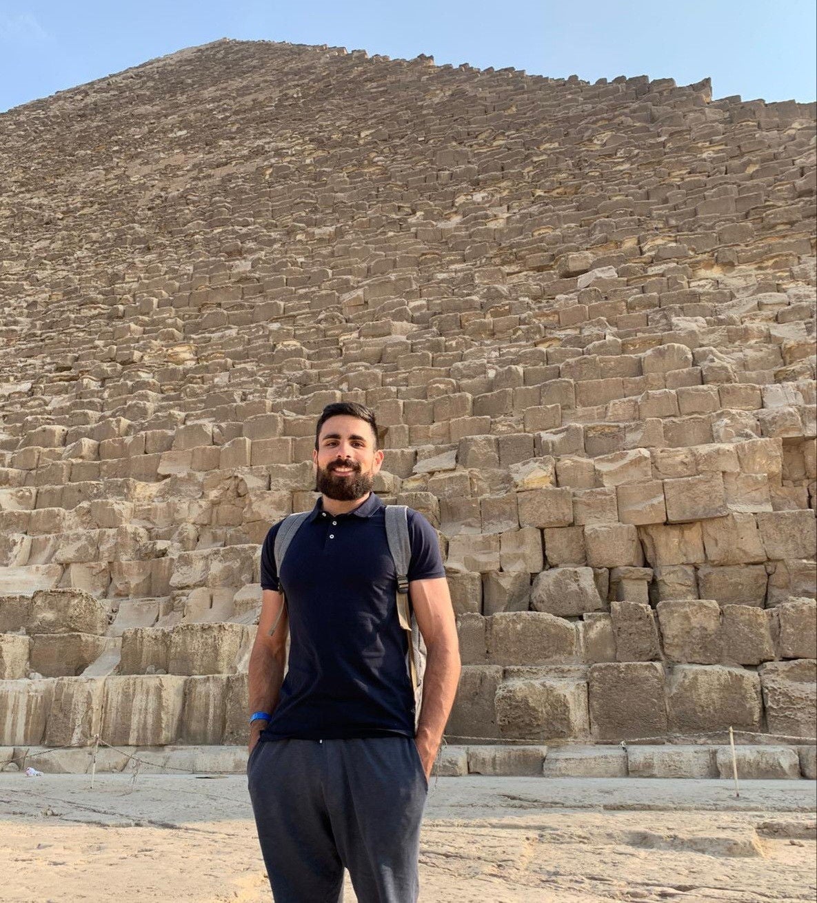 Man standing infront of pyramid