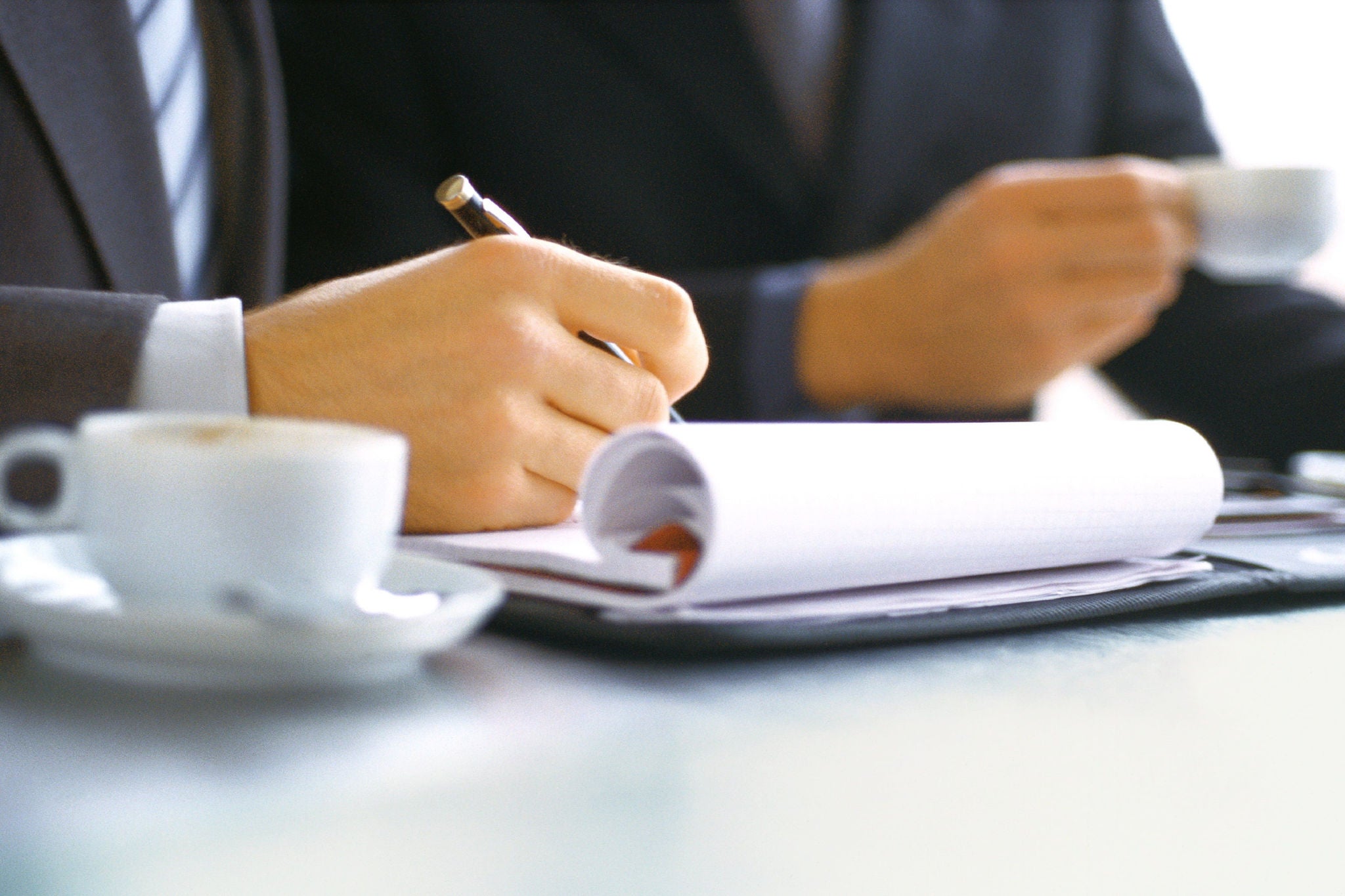 A man writing important points in book