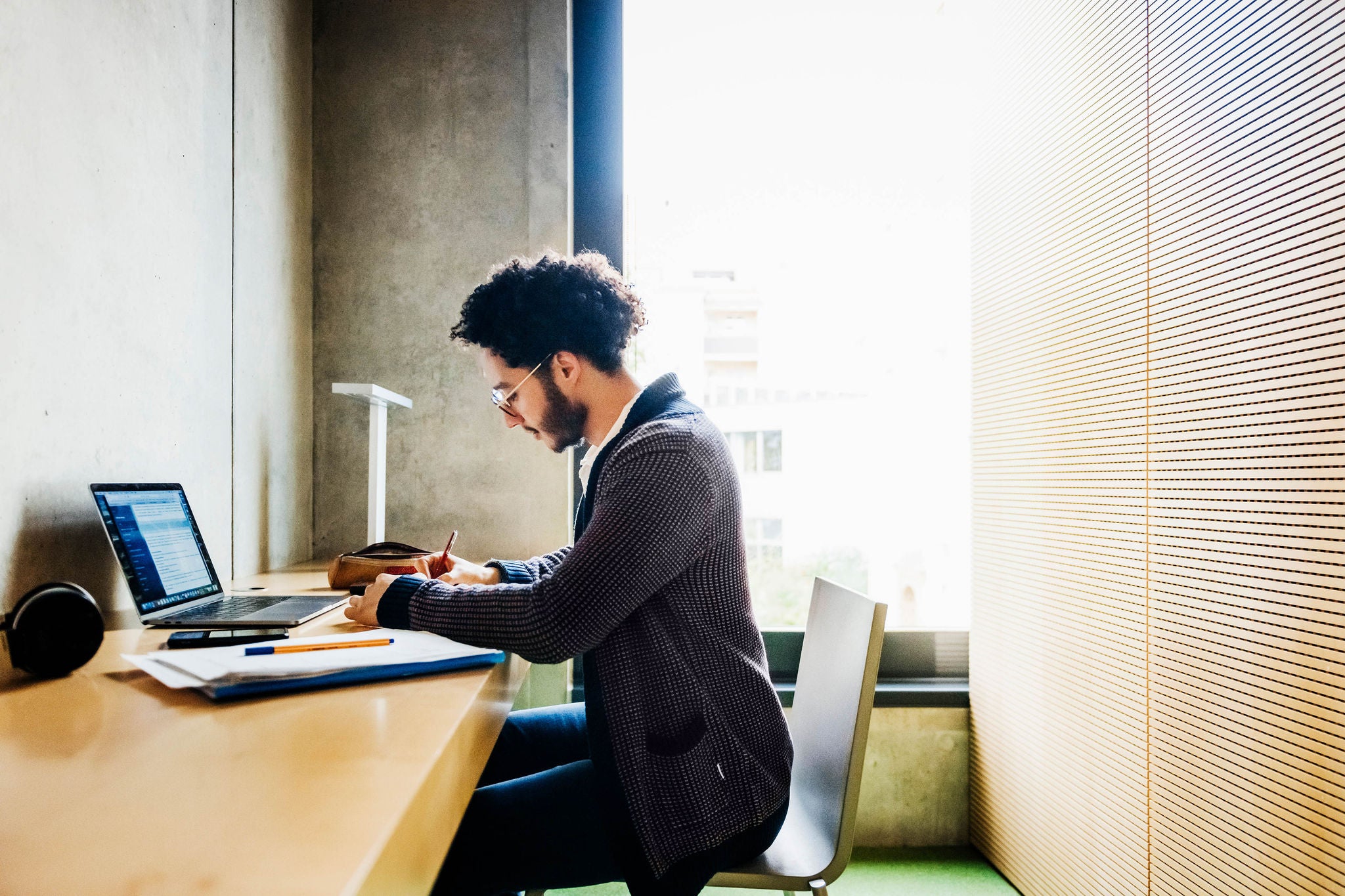 Young Man Sitting working in modern room