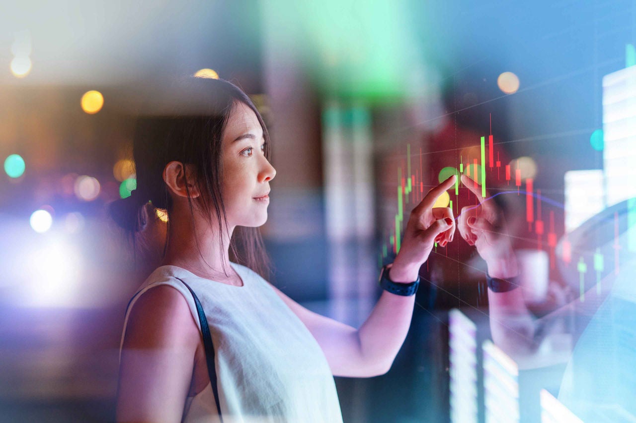 woman touching screen on futuristic digital display.