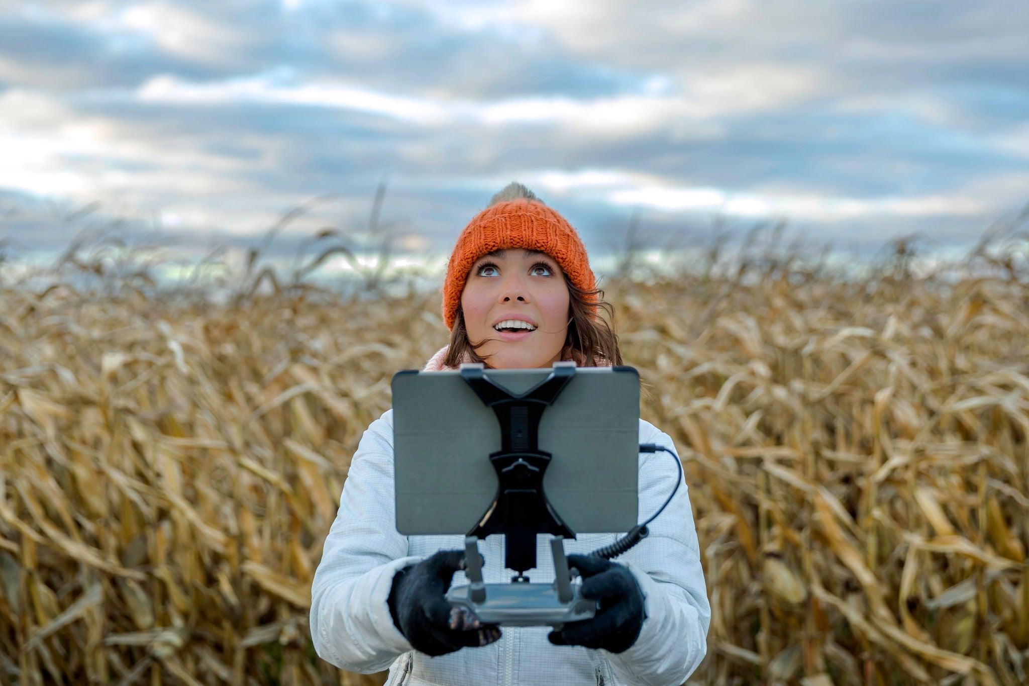 Woman Pilot Using Drone Remote Controller with a Tablet Mount