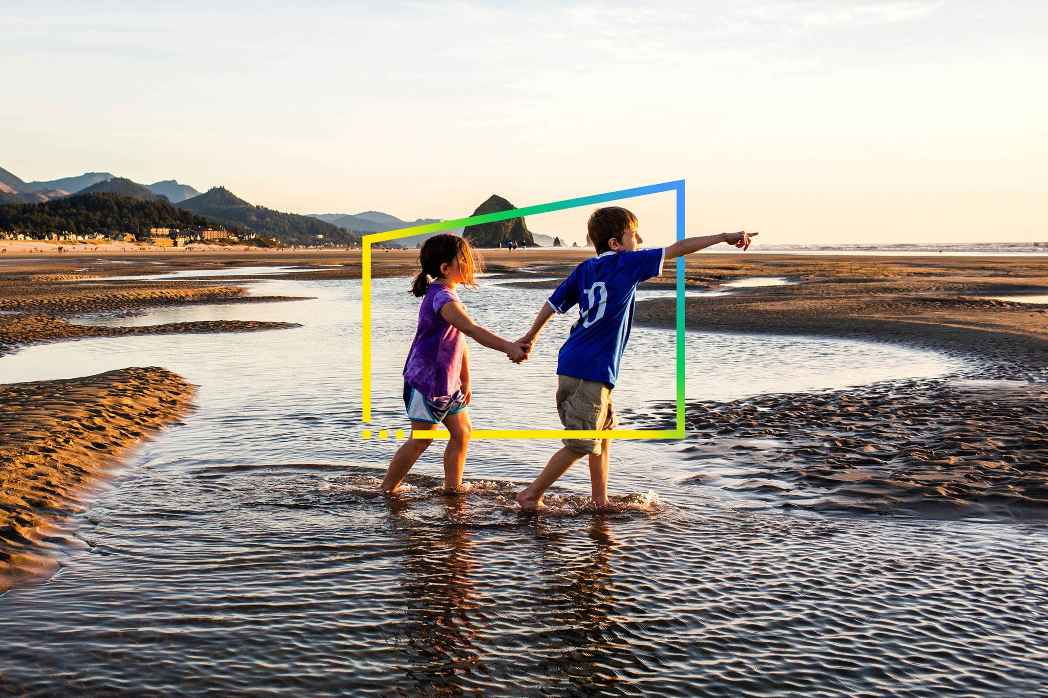 Caucasian children walking in tide pools on beach frame