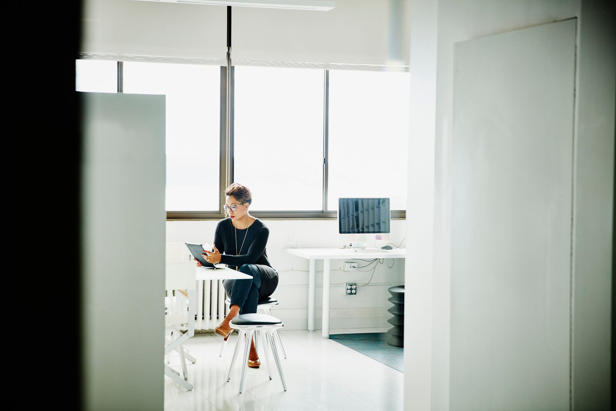 Female business owner working on digital tablet in office