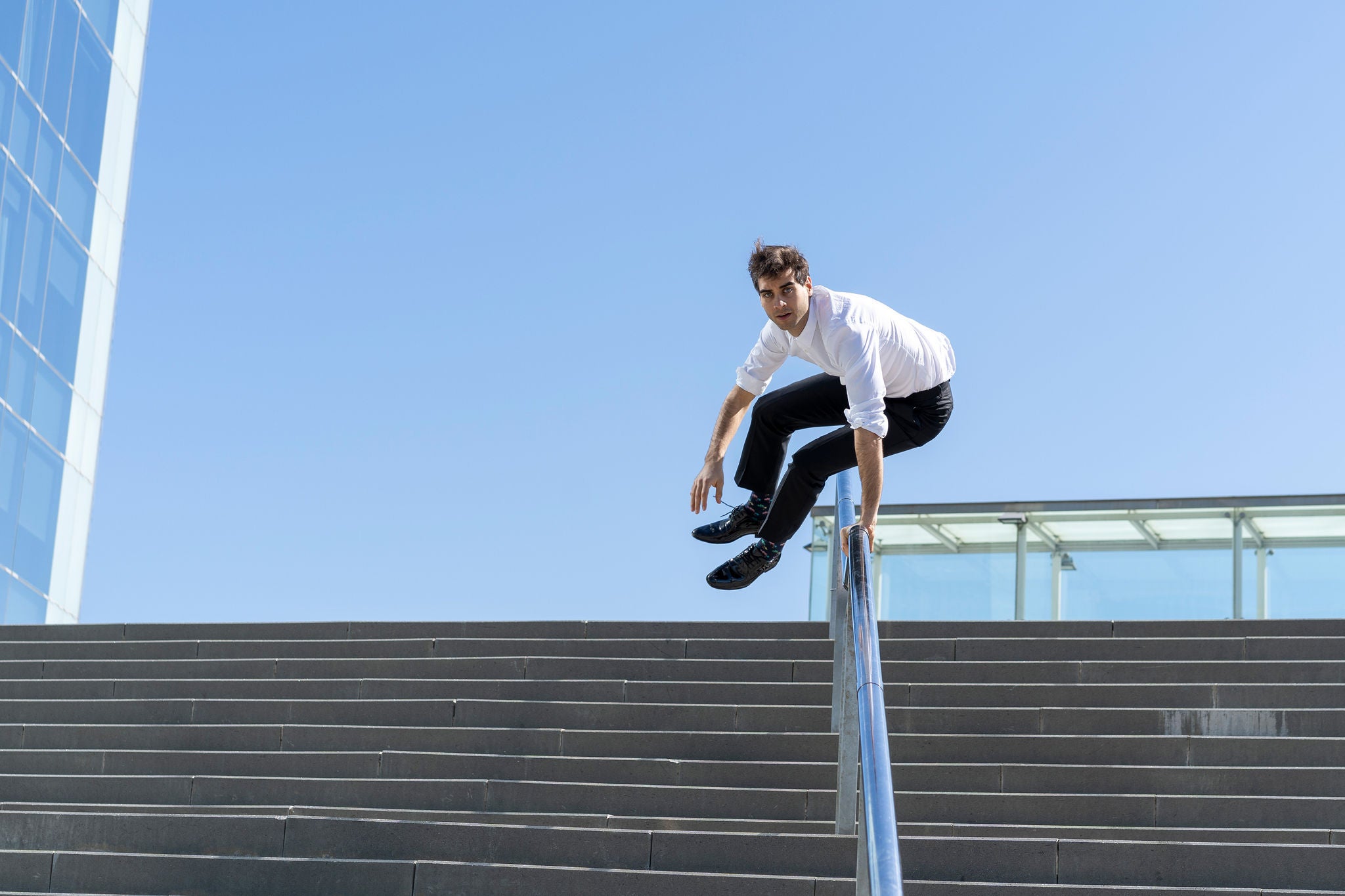 Businessman crossing banister in the city