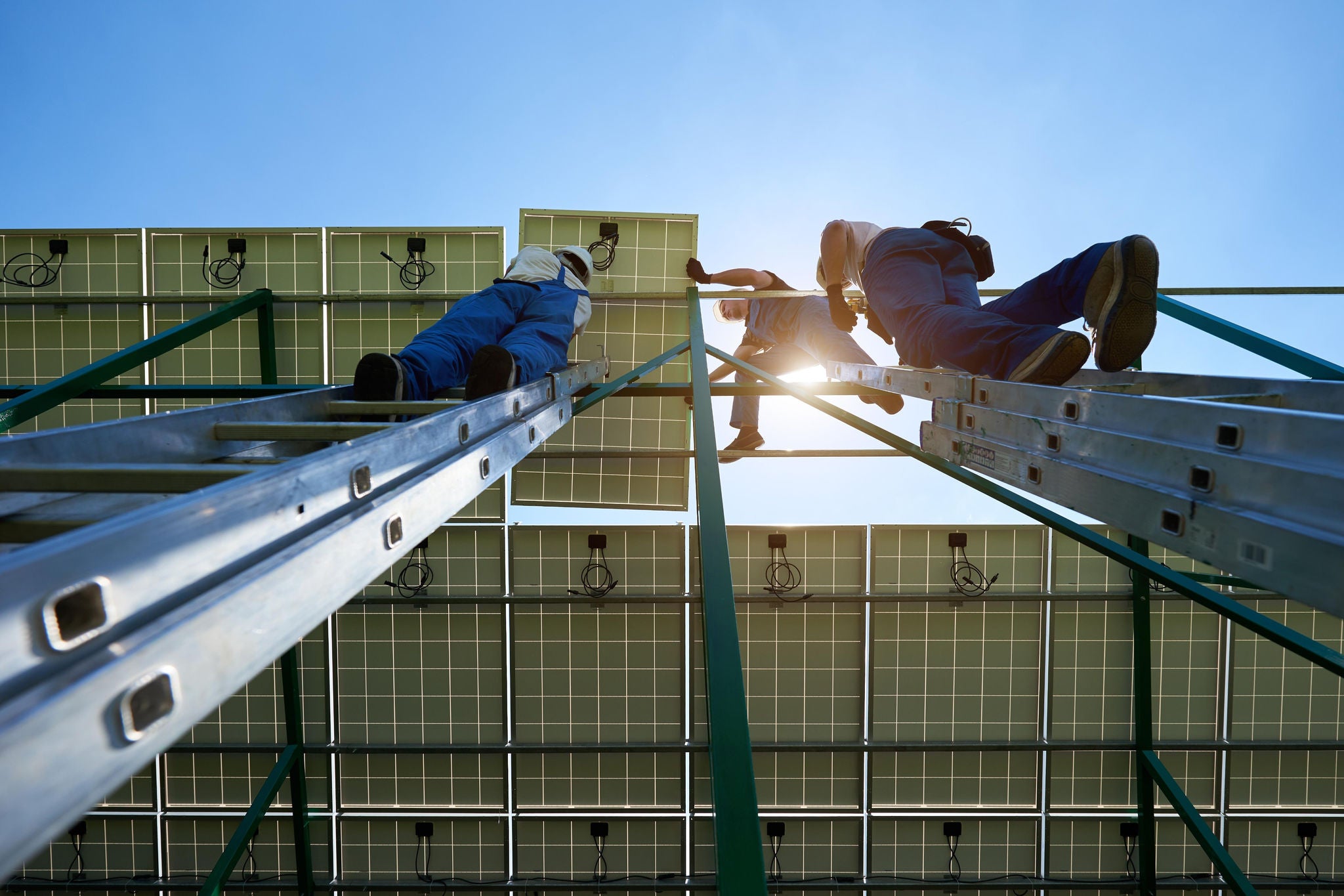 Professionals working on solar panels