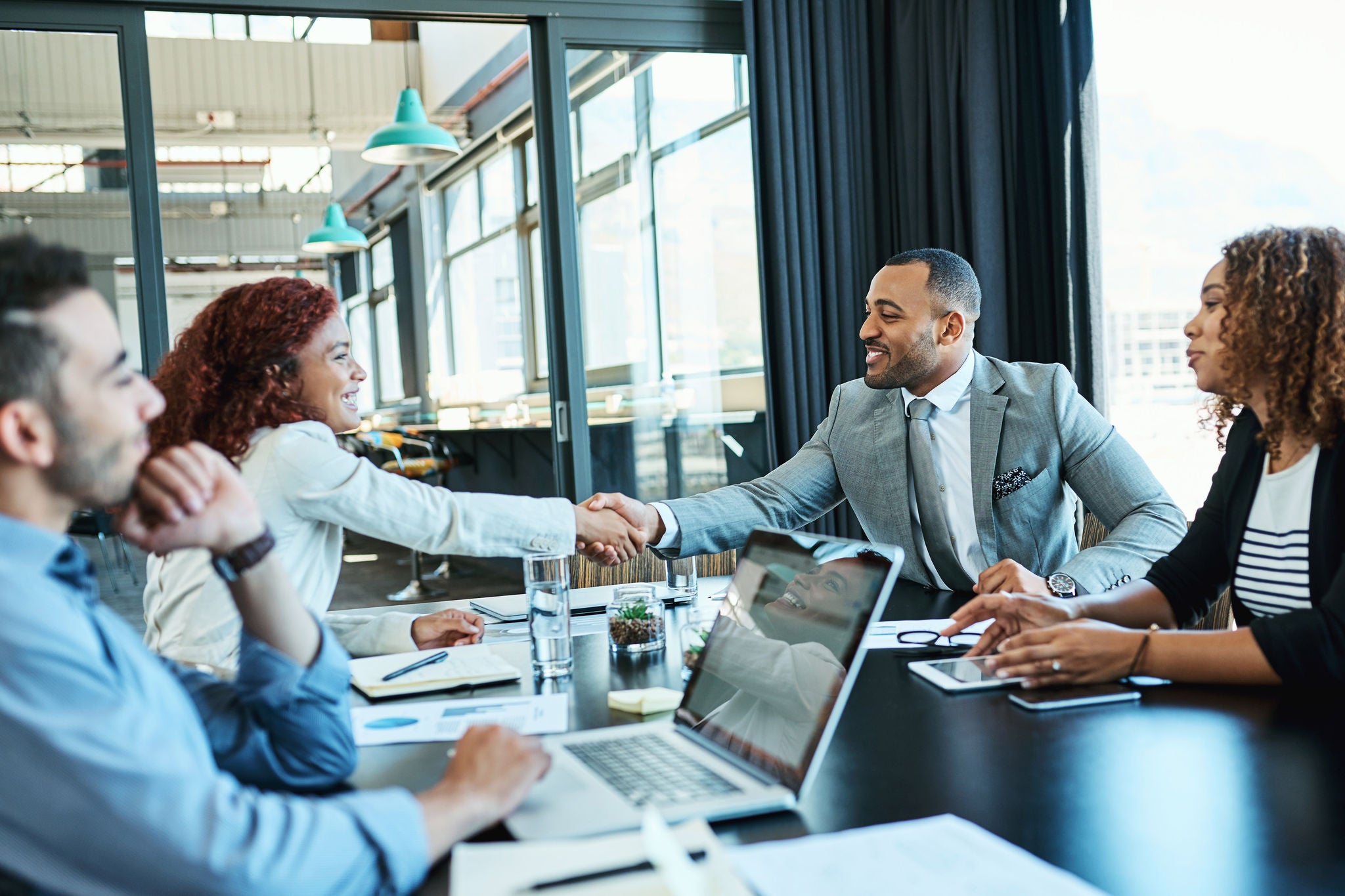 businesspeople shaking hands meeting office