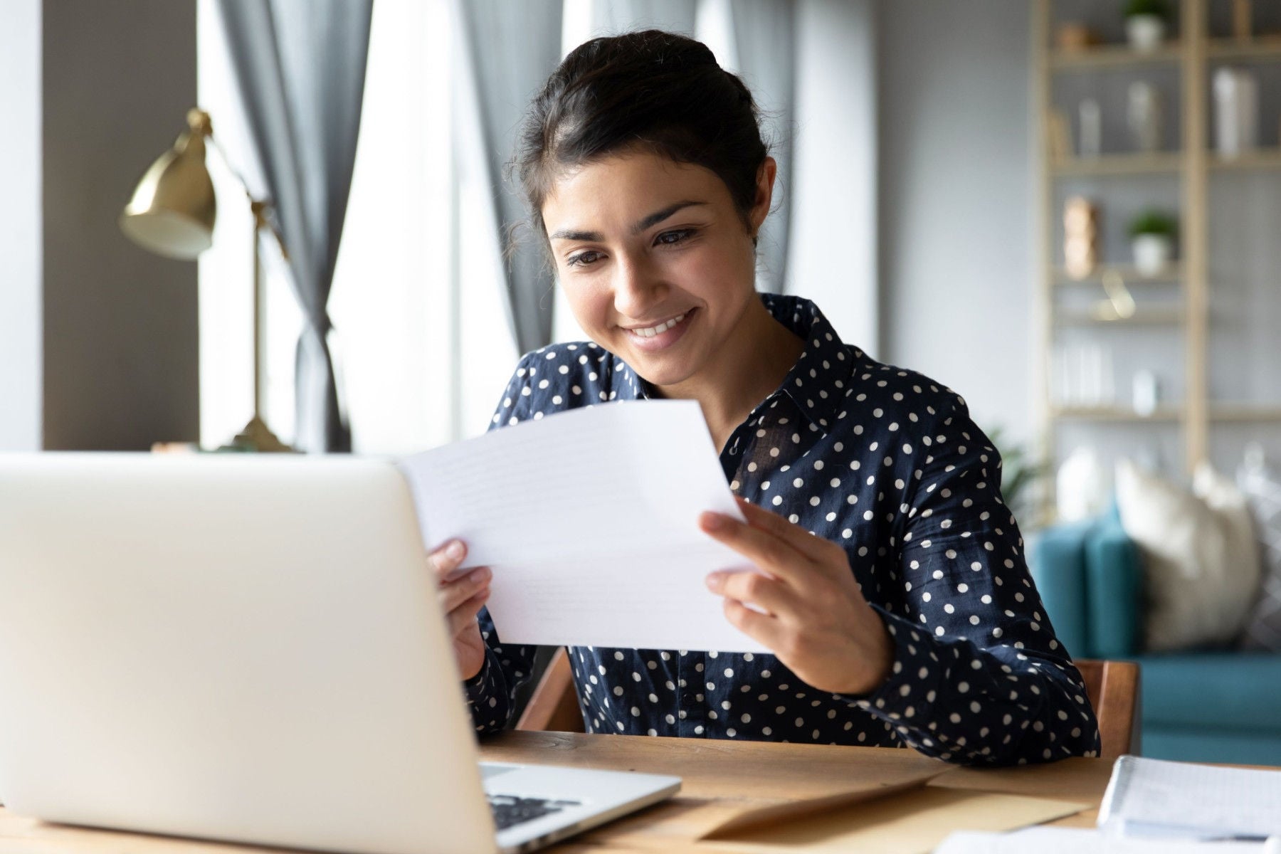 Ey women smiling at a document