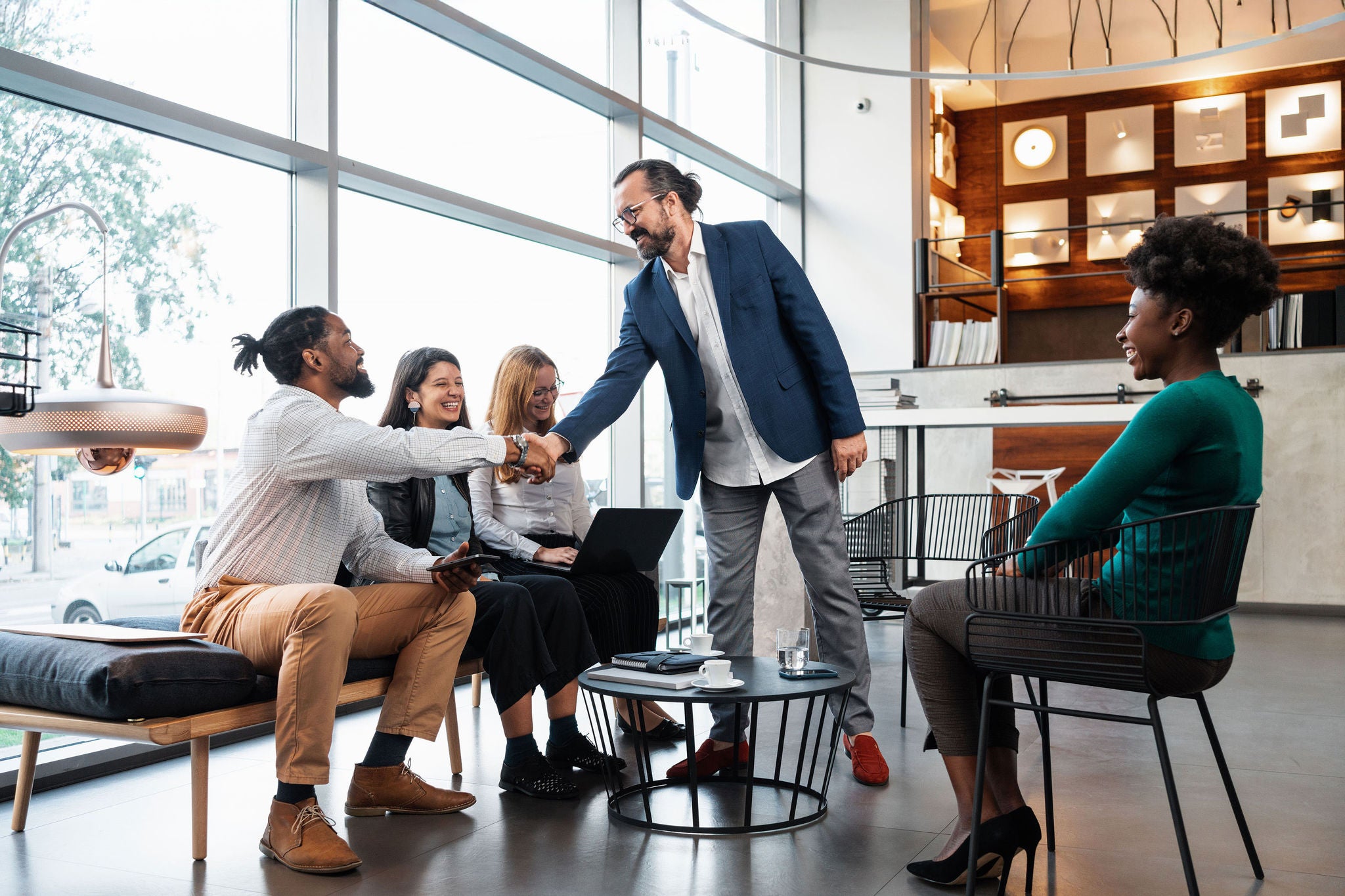 Business Associates Shaking Hands In A Meeting