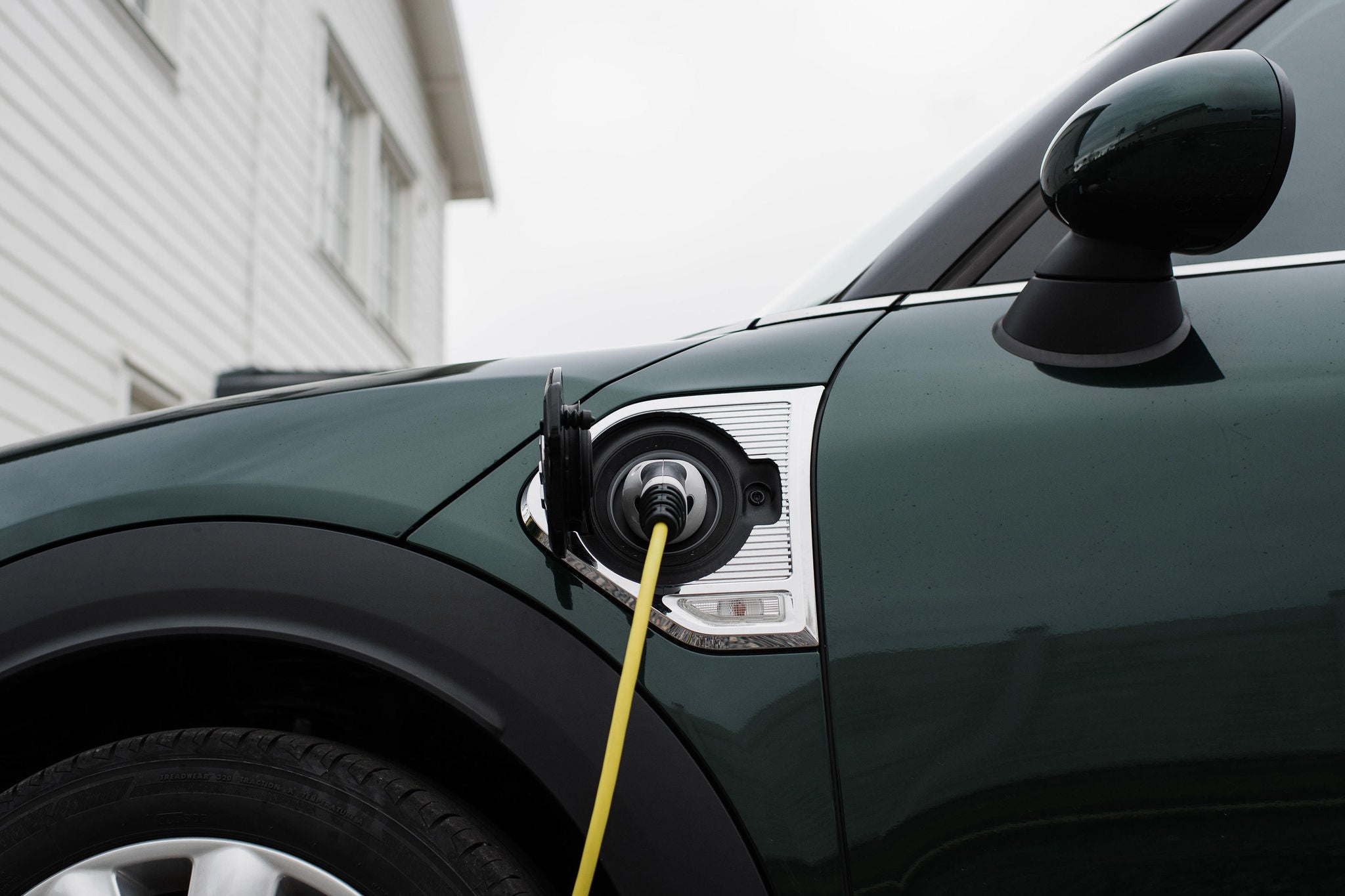 electric car lead plugged into an electric car at home