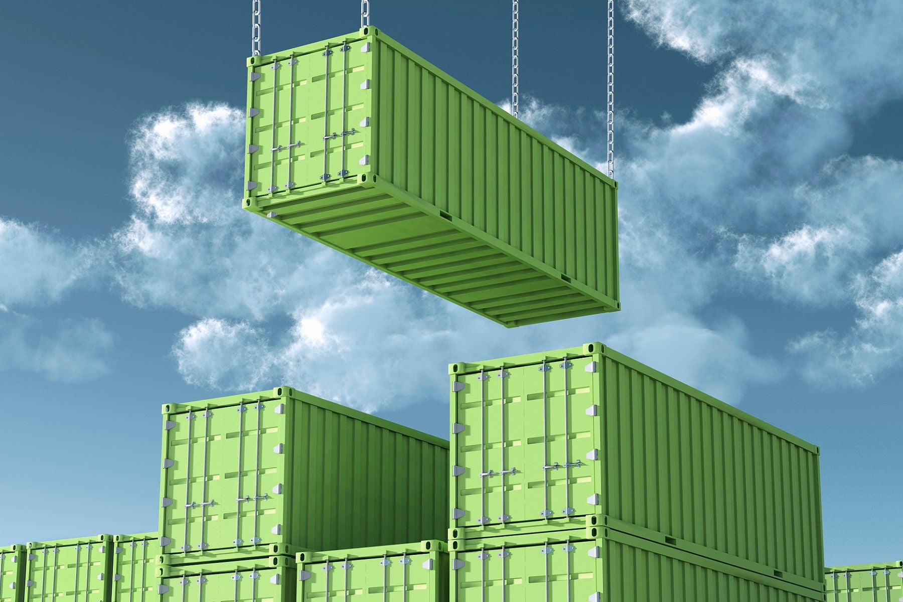 International Cargo Container, one is lifted up, under a sunny blue sky with clouds