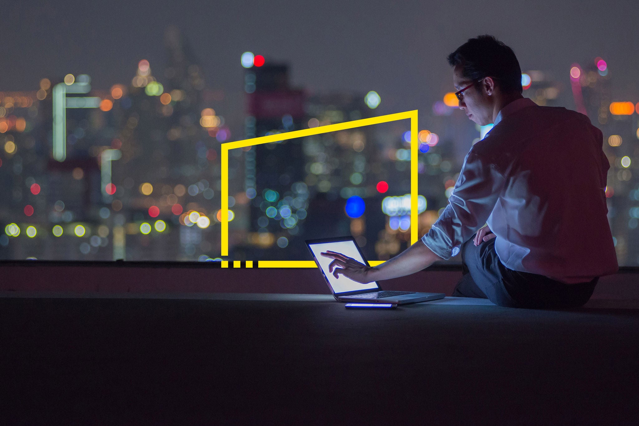 Business man working late on rooftop