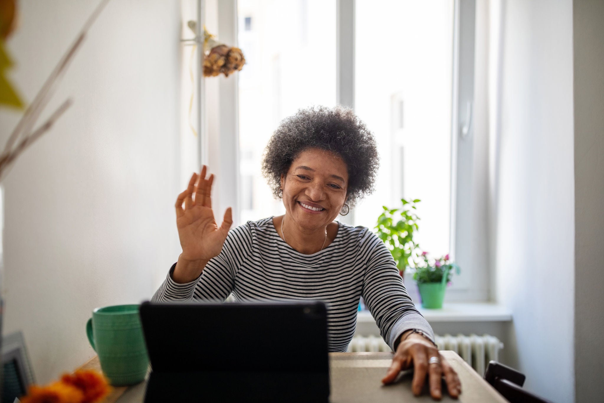 Women using laptop greeting