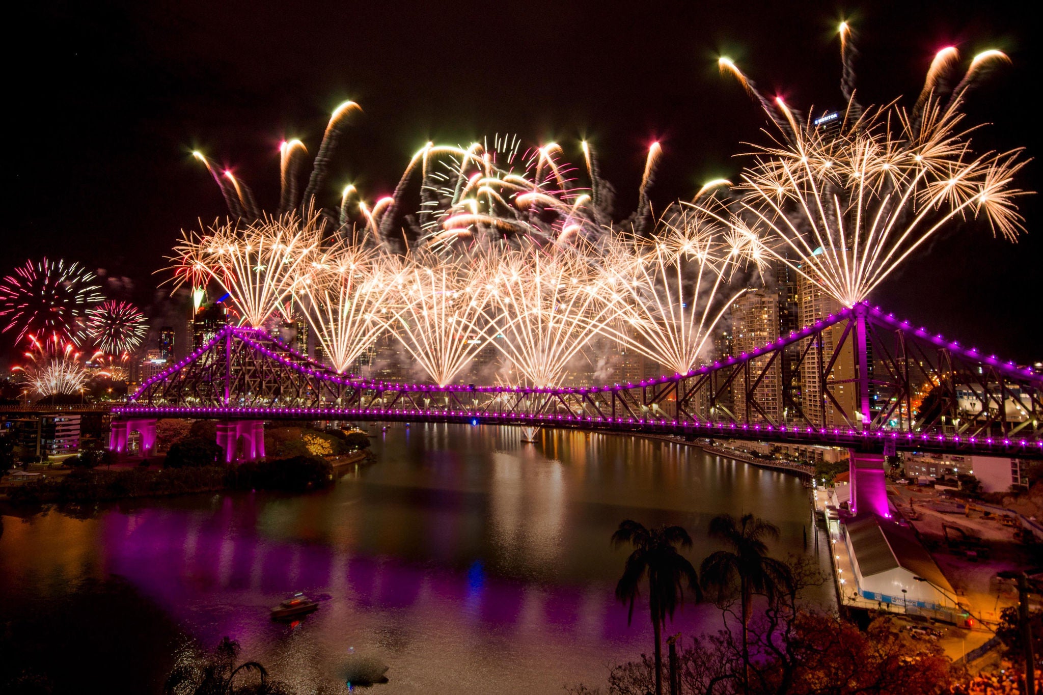 Firework display over river at night