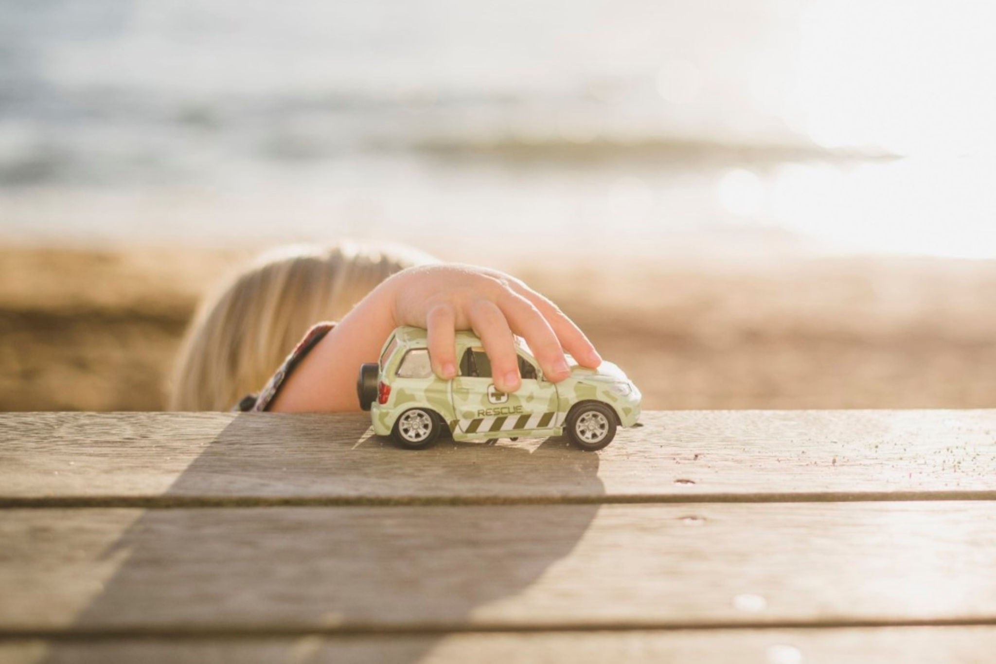 A child playing with toy car