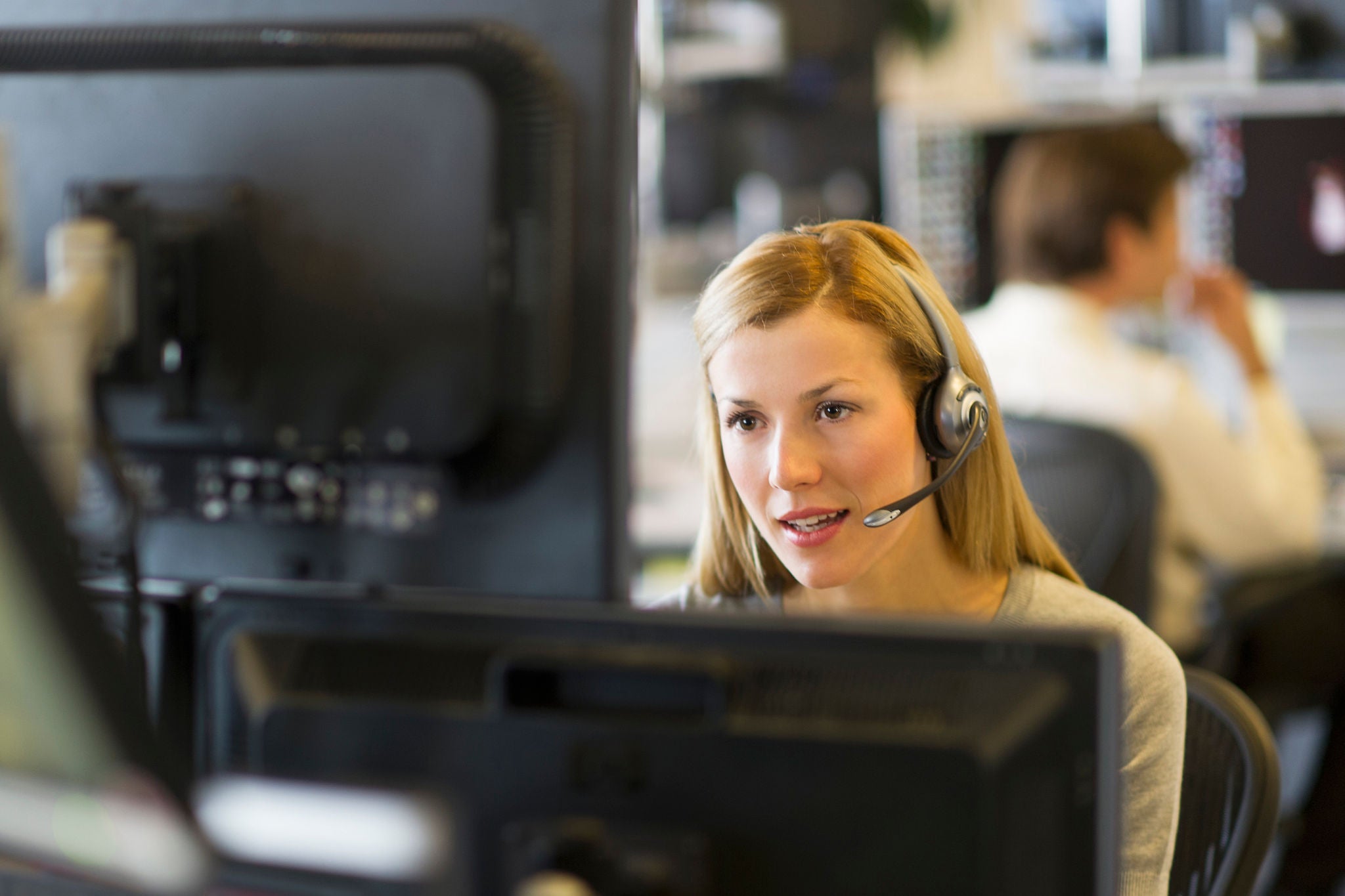 Woman trader desk headset new york