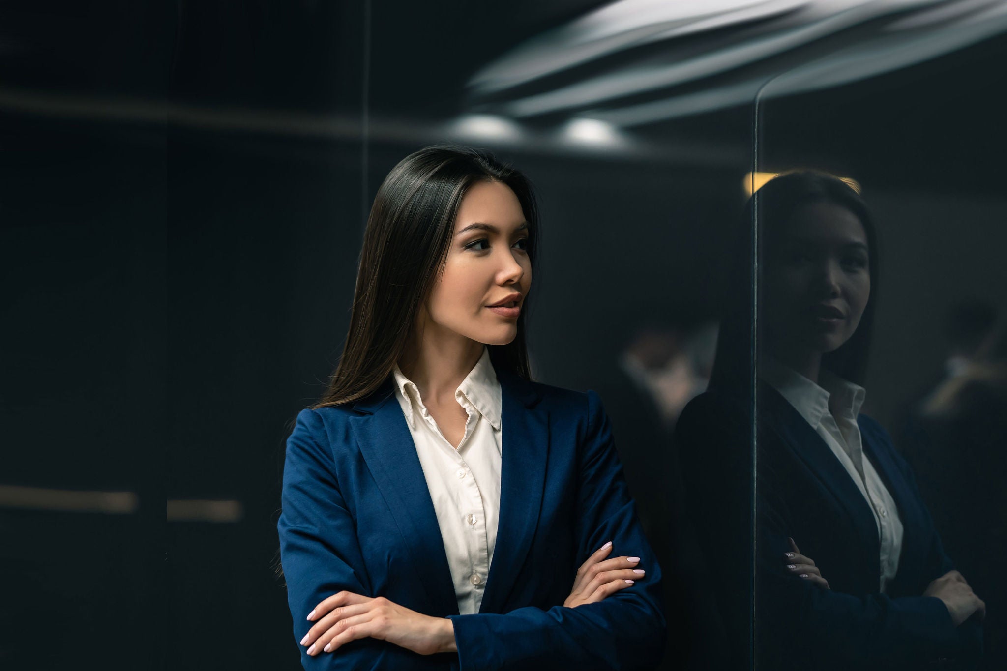 Businesswoman standing apart with reflection