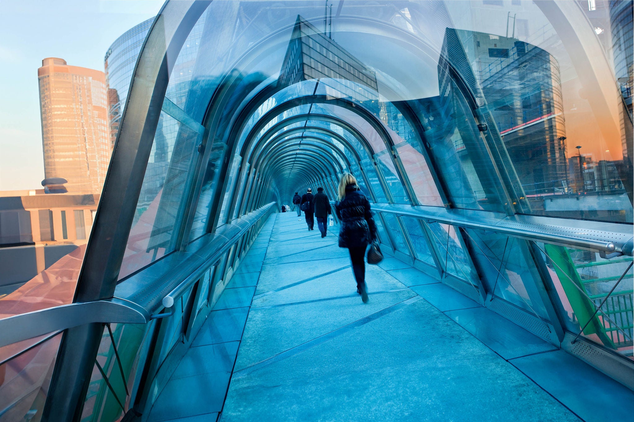 people walking across bridge in la defense static