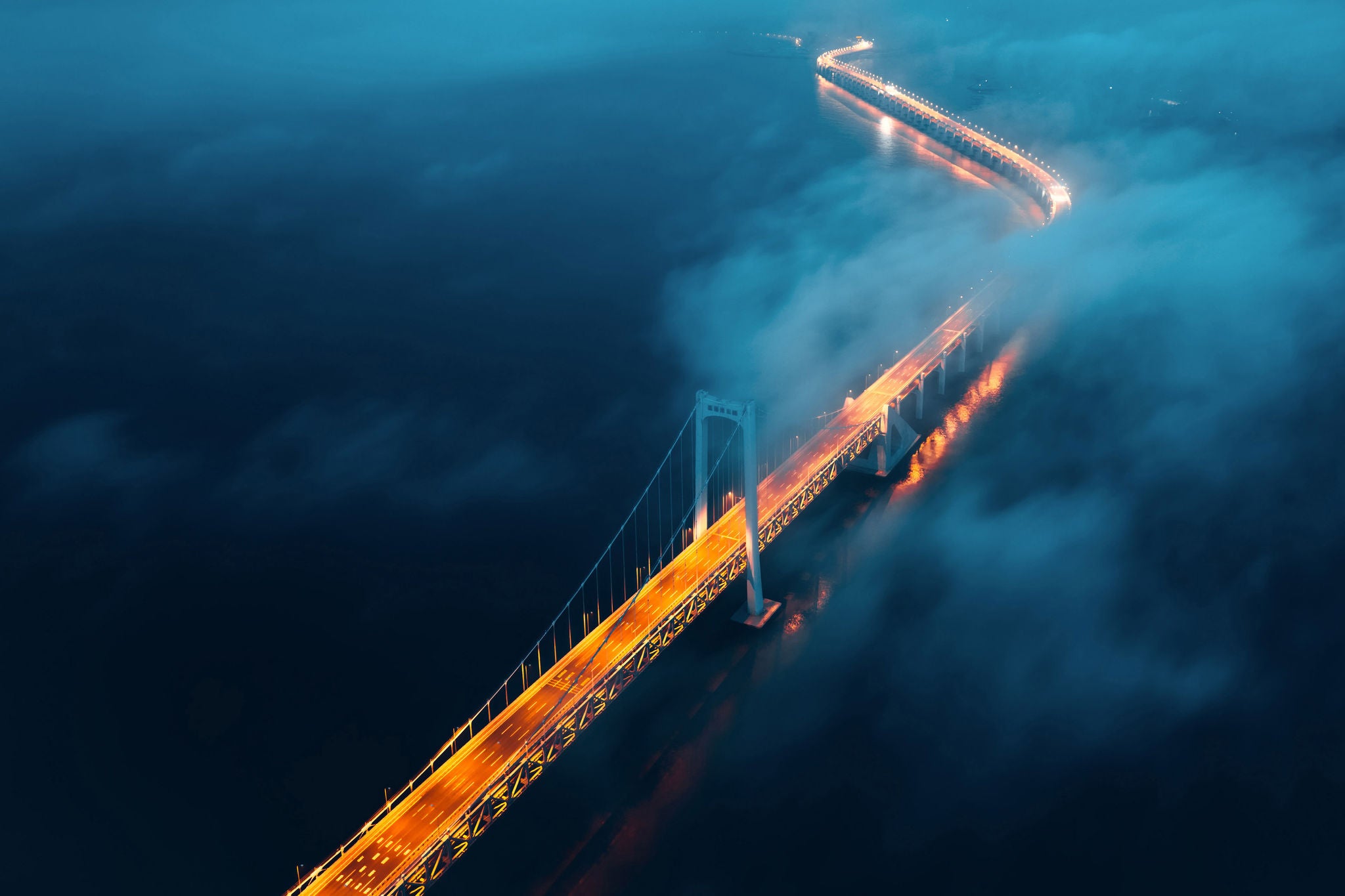 A cross sea bridge in the fog at night background